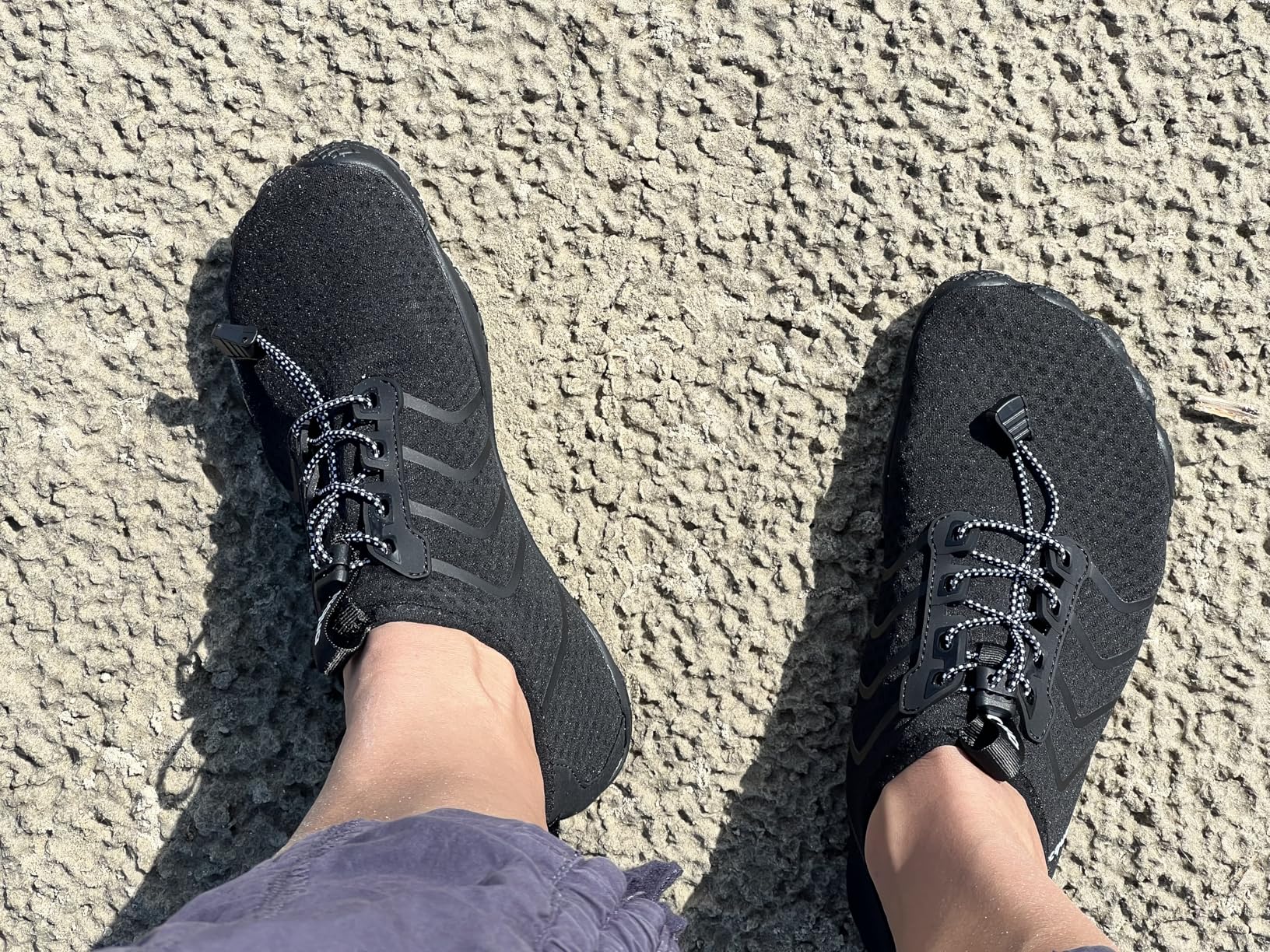 Racqua water shoes in black showing barefoot design, quick-dry mesh upper, and minimalist water shoe construction