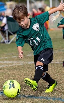Action shot of young player in bright Vizari Stealth cleats demonstrating agility during game play