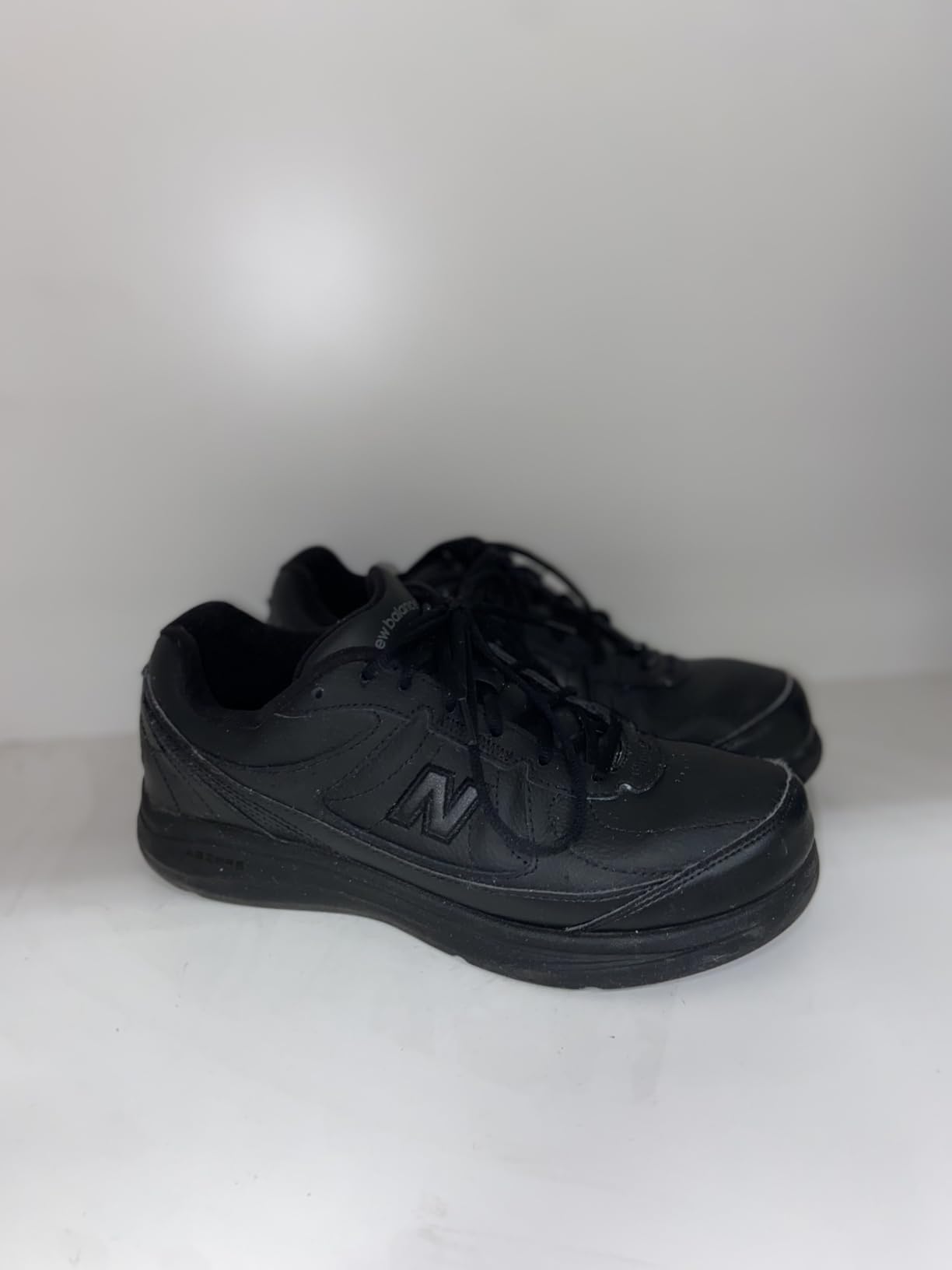 New Balance Men's 577 V1 black leather walking shoe with lace-up design on clean background