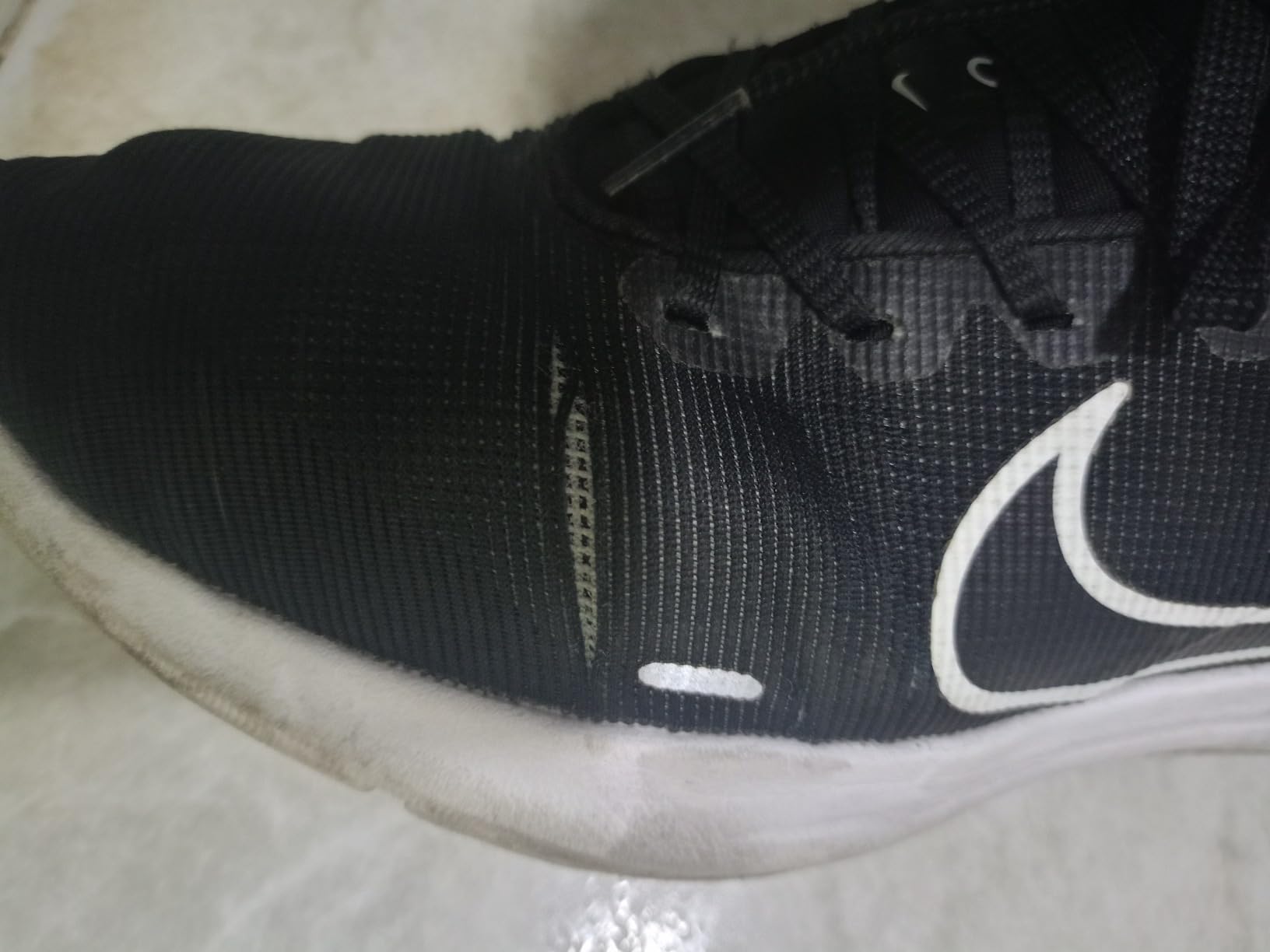 Nike Downshifter 12 outsole showing rubber traction pattern and wear after 8 weeks of testing