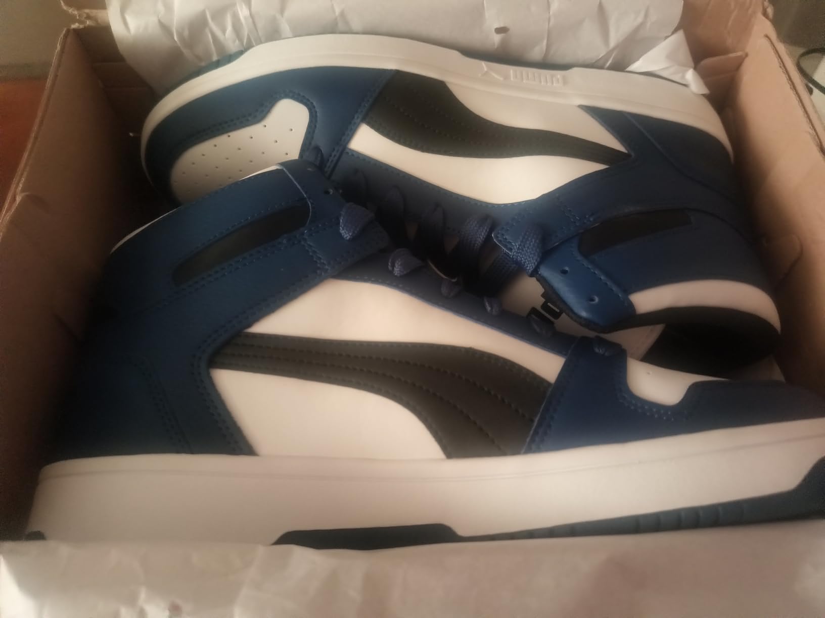 PUMA Rebound Layup upper construction showing synthetic leather texture, mesh panel integration, and PUMA Formstrip detail