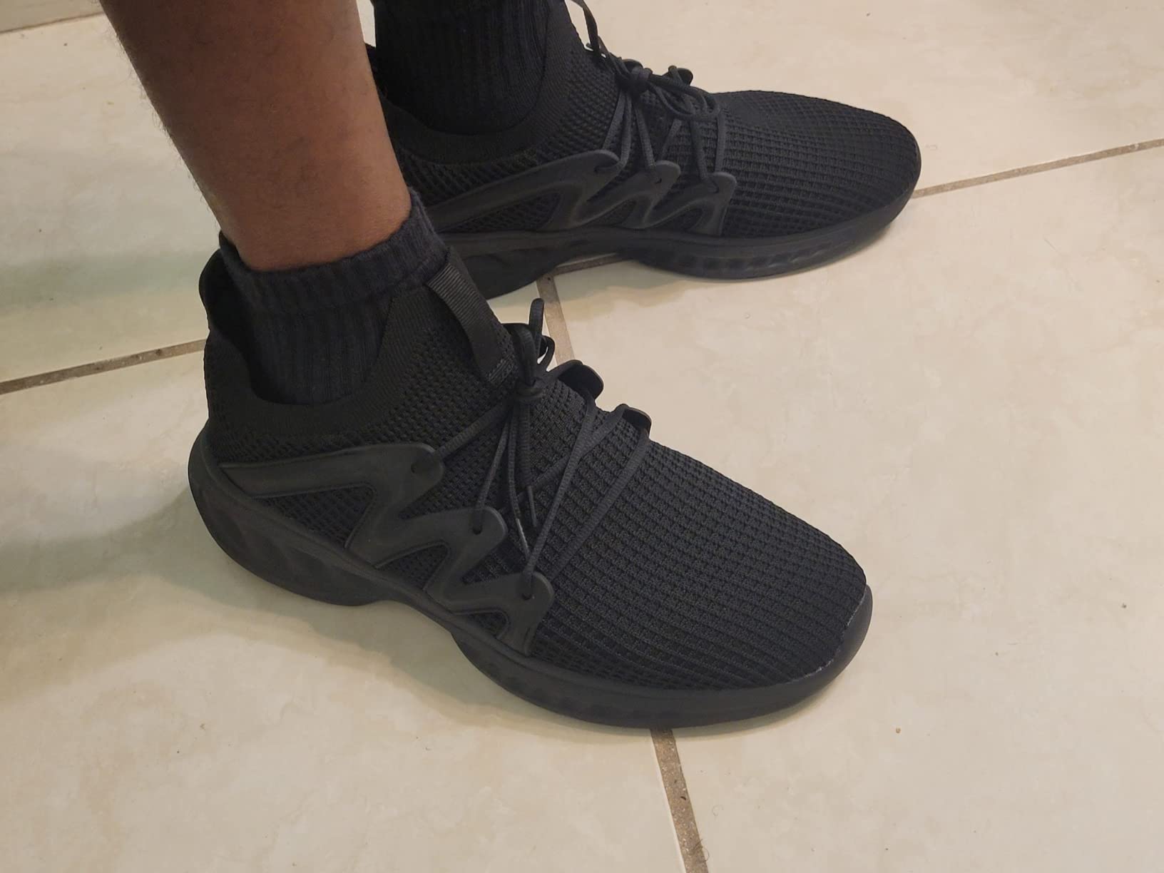 Close-up detail shot showing Pujcs walking shoes mesh upper construction and traditional lacing system