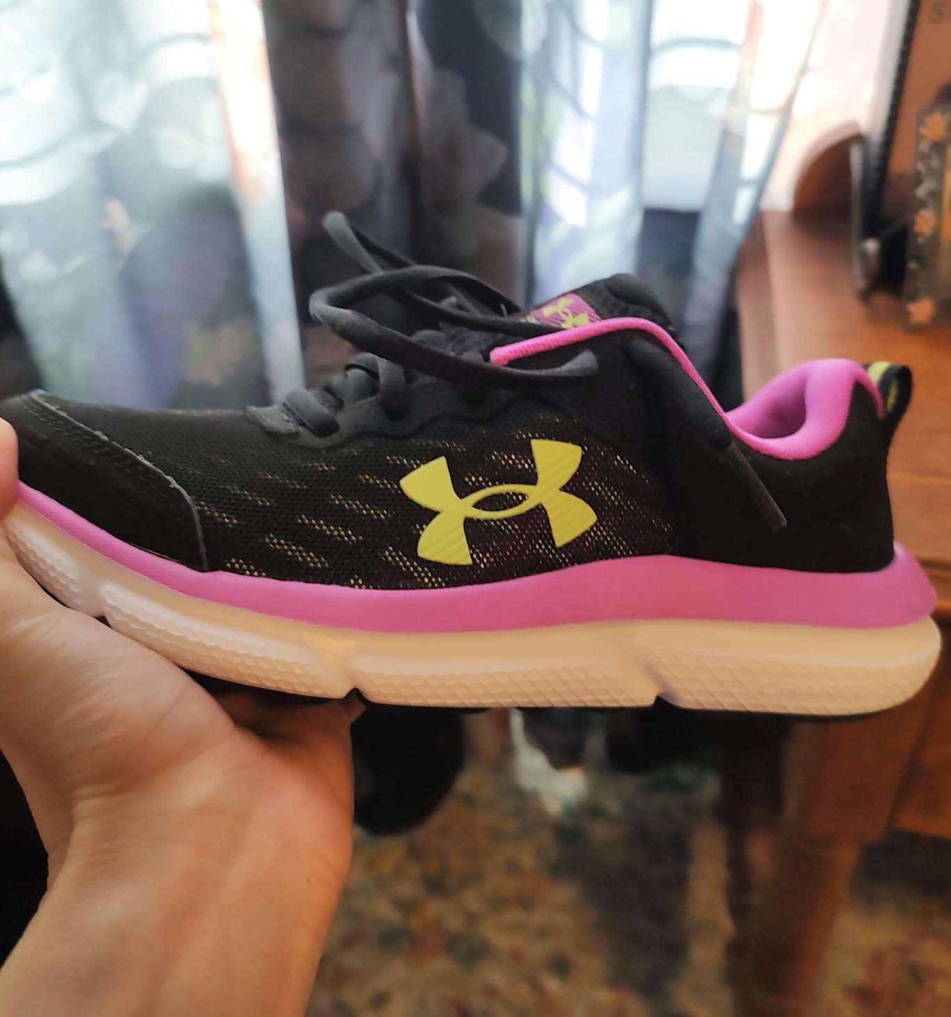 Under Armour Assert 10 Kids Grade School shoes showing mesh upper and EVA midsole construction
