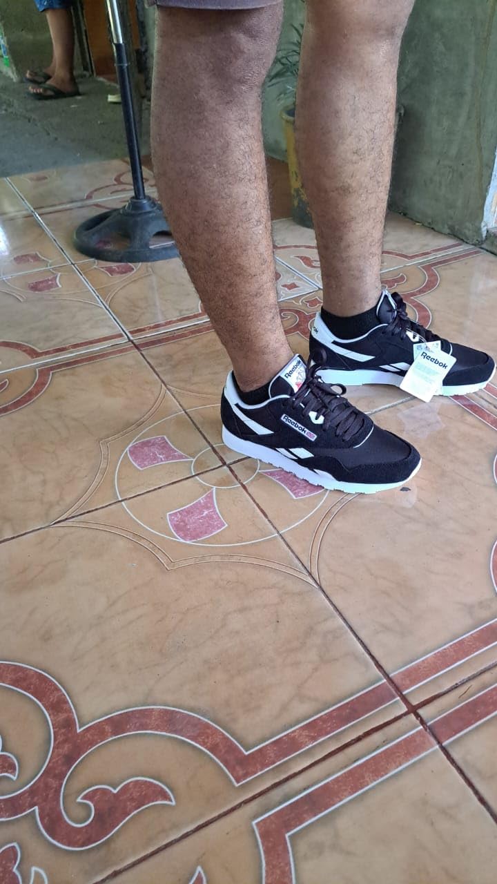 Bottom sole view of Reebok Classic sneaker showing rubber outsole traction pattern and heel design