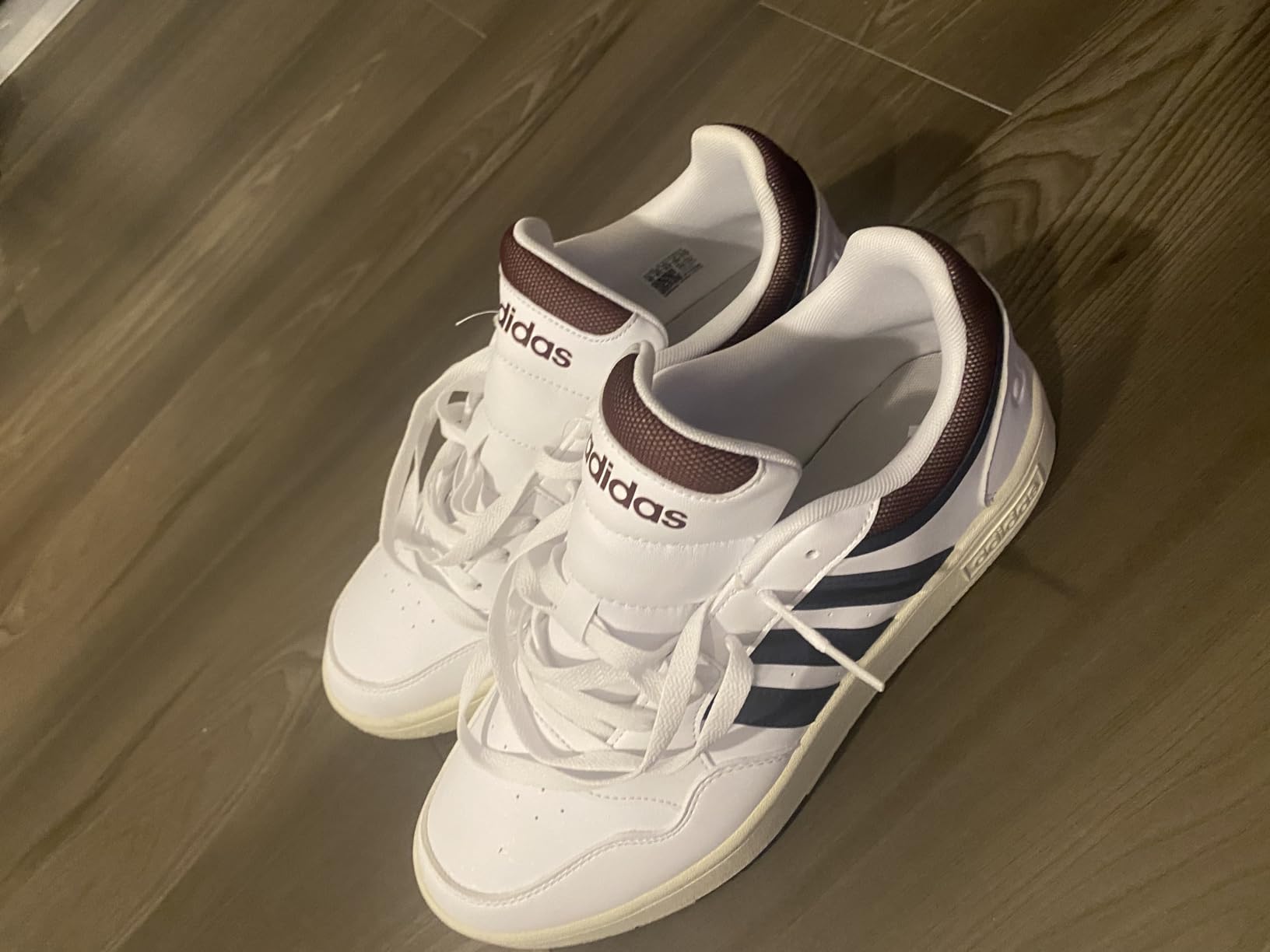 Lifestyle shot showing Adidas Hoops 3.0 versatility for both court and casual wear