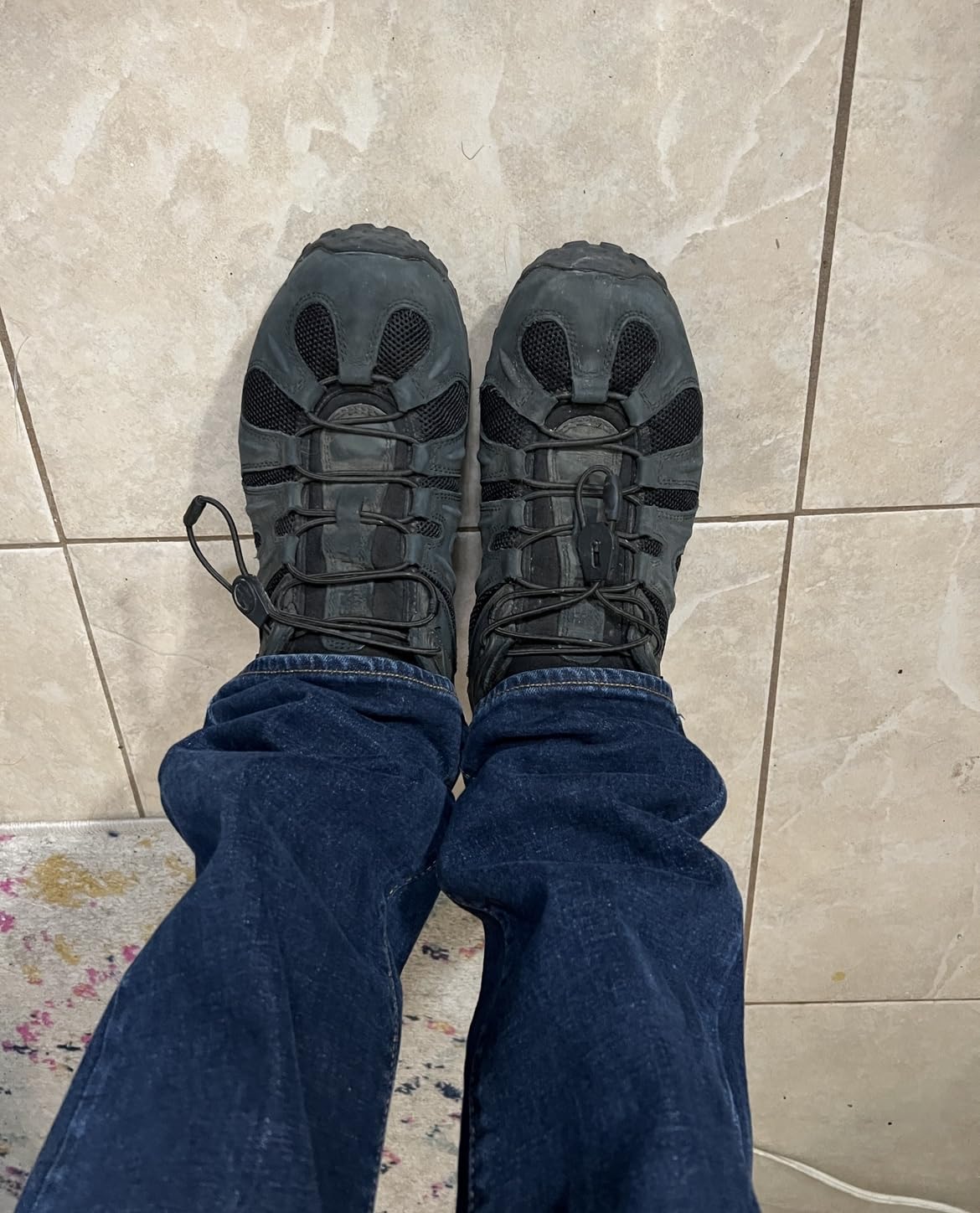 Action shot of Merrell Chameleon 8 during trail hiking showing ankle stability and outdoor performance