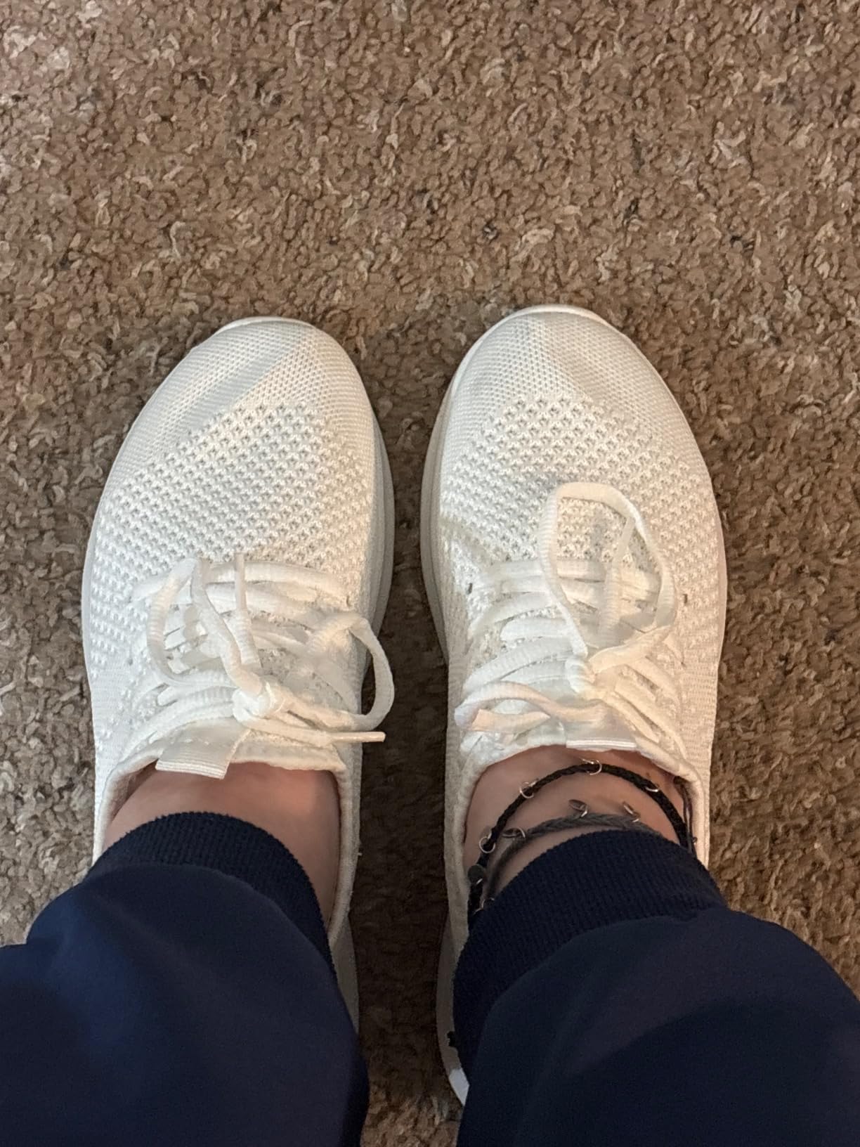 Close-up detail of WYGRQBN walking shoes showing breathable mesh upper texture and EVA sole construction