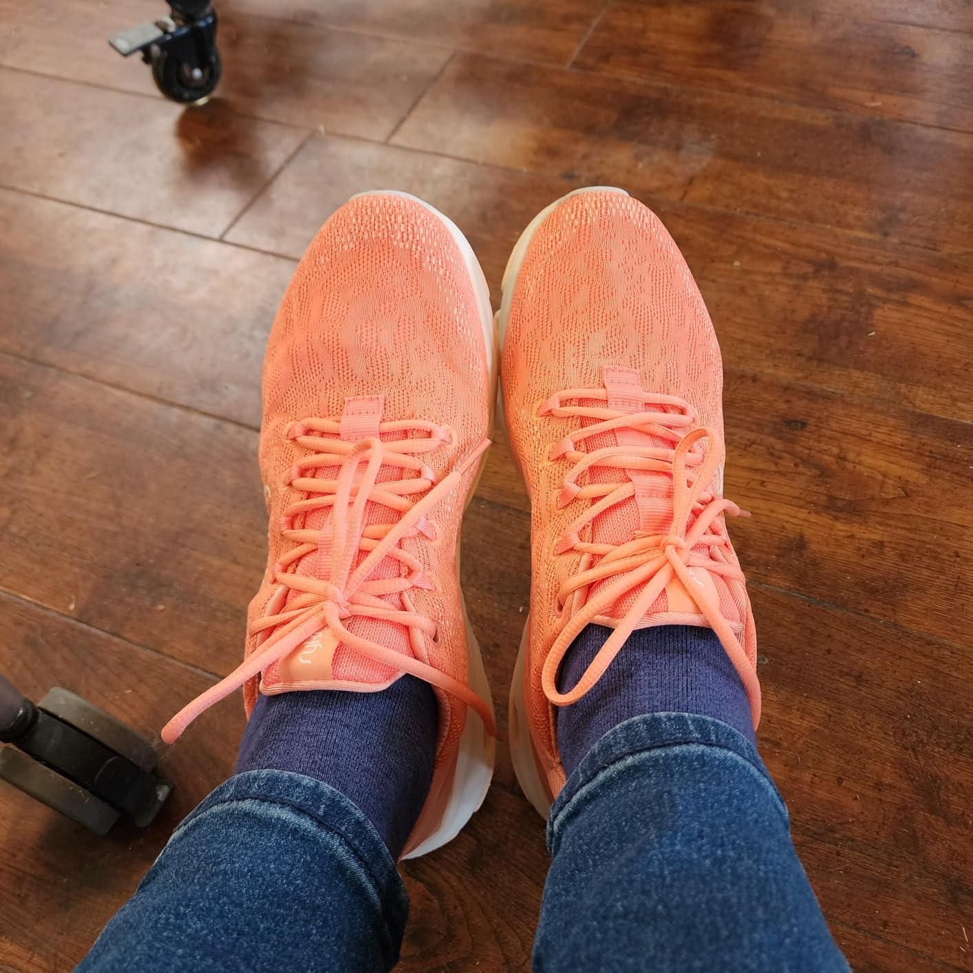 Ryka Devotion X in coral orange colorway showing the shoe's versatile styling for active lifestyle use