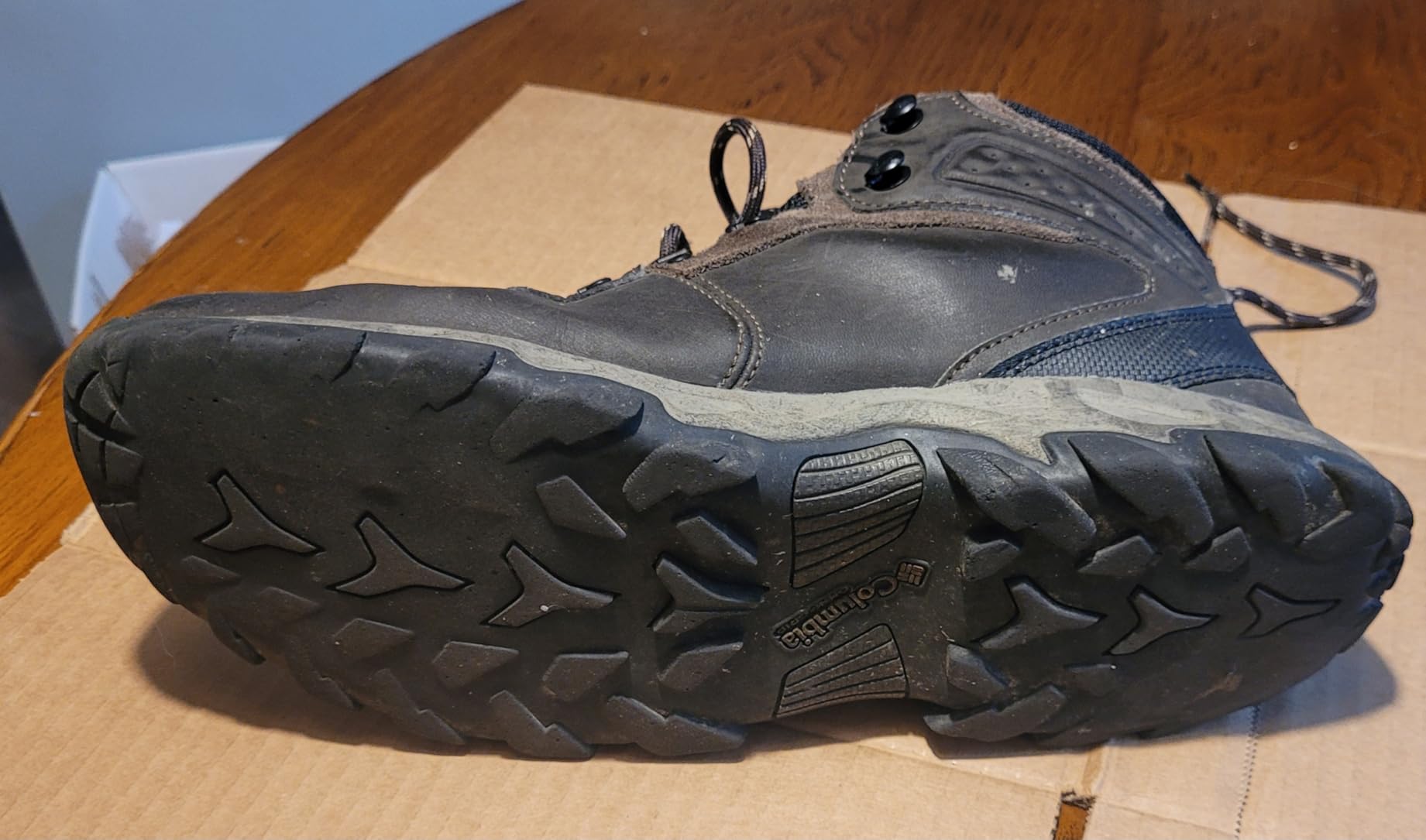 Columbia Men's Newton Ridge Plus II waterproof hiking boots in brown leather with black accents on white background