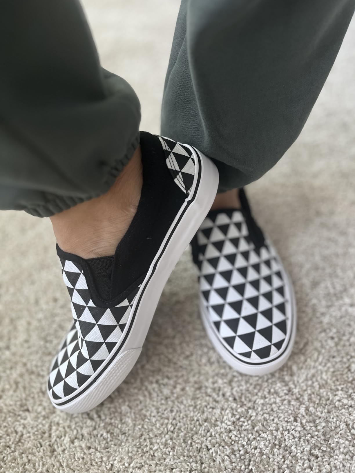 Close-up detail of canvas upper texture and elastic side panels on the slip-on sneaker construction
