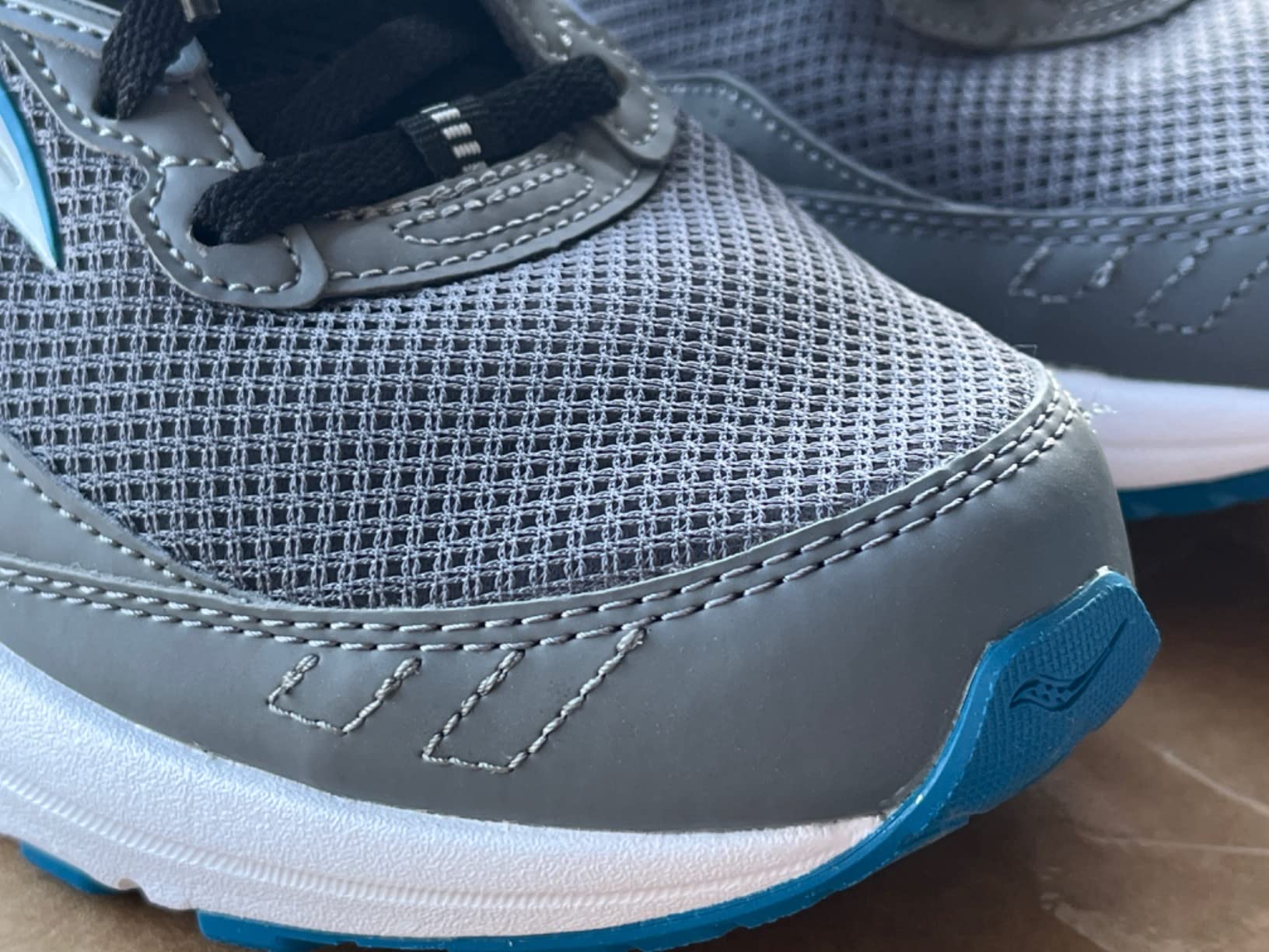 Saucony Cohesion 15 side profile showing VERSARUN midsole stack and heel counter construction
