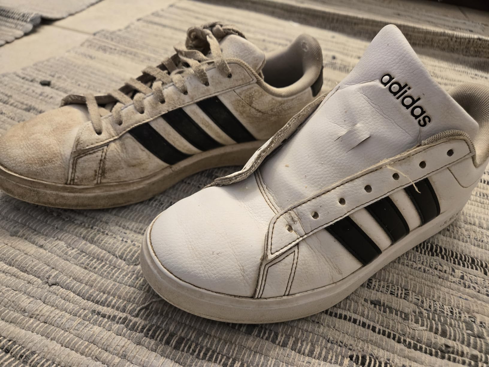 Heavily soiled white sneakers with mud and grime buildup before SneakERASERS cleaning treatment
