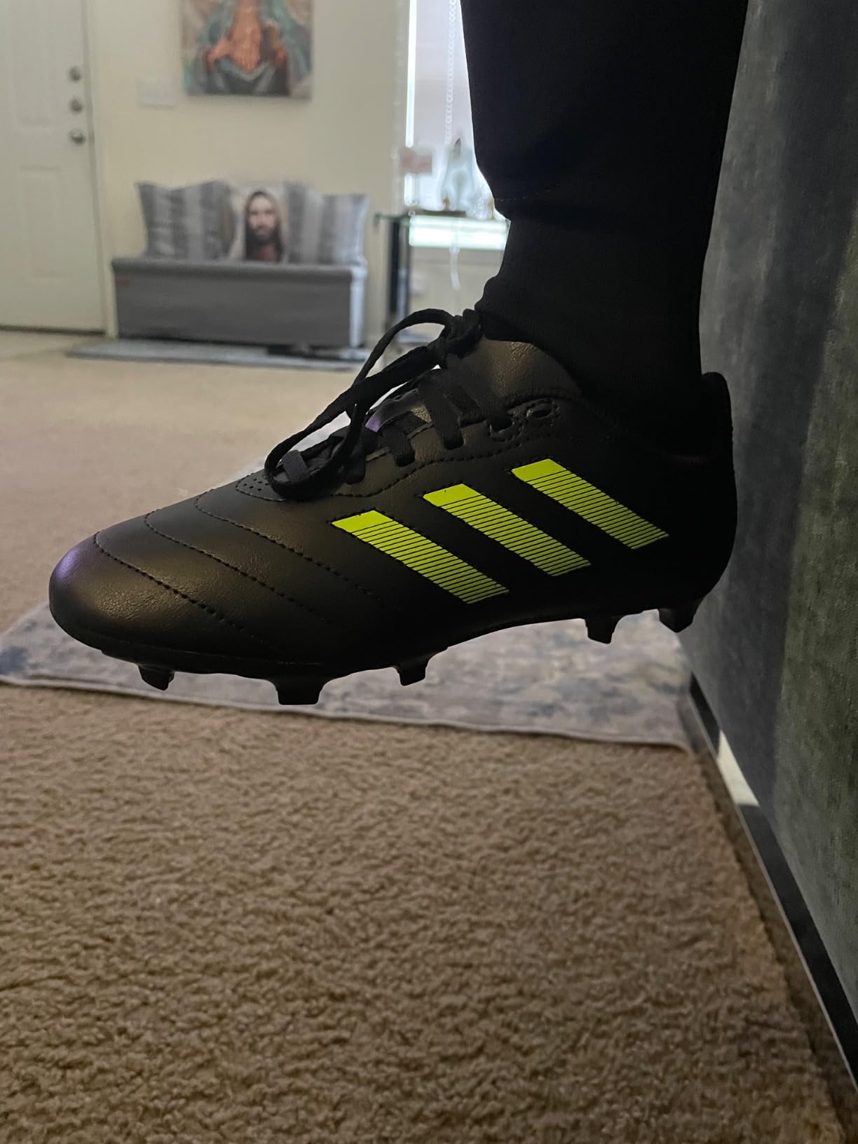 Adidas Goletto VII FG kids soccer cleats black and blue colorway showing firm ground stud design