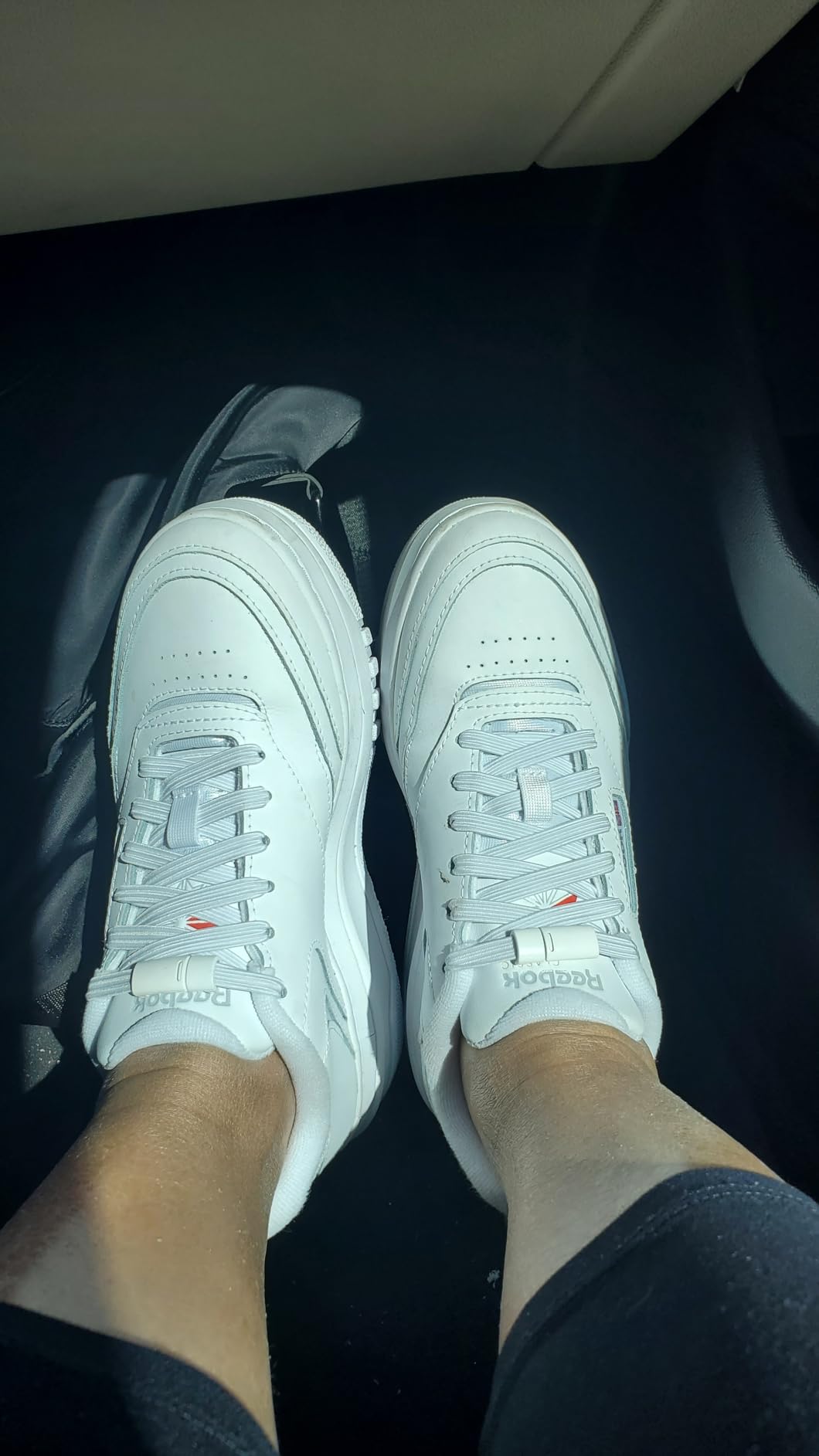 Detailed view of Reebok Club C Extra showing perforated leather details and padded collar construction