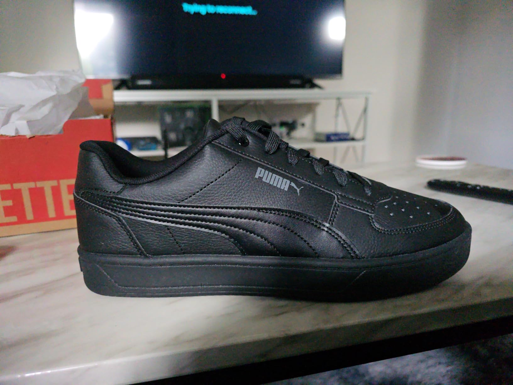 PUMA Caven 2.0 close-up showing leather upper construction and iconic Formstrip branding detail