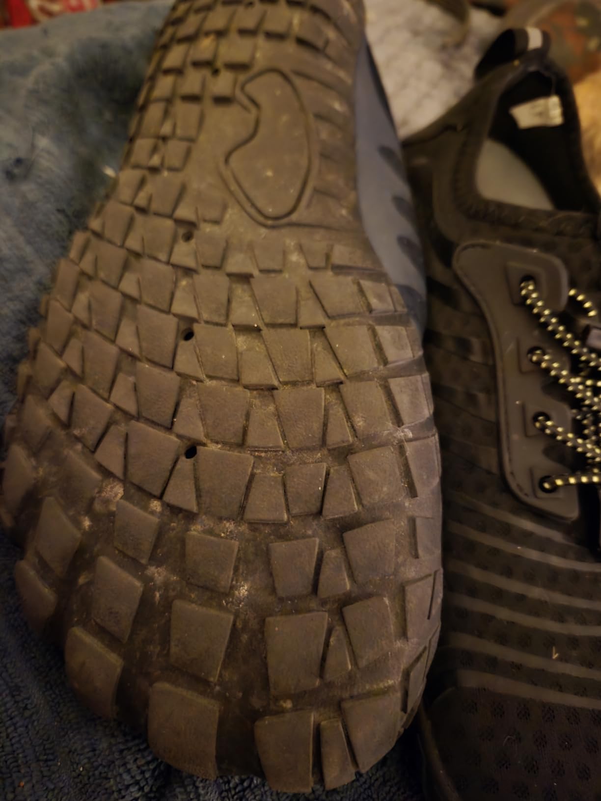 Bottom view of Ziitop water shoe showing seven drainage holes and rubber tread pattern in detail