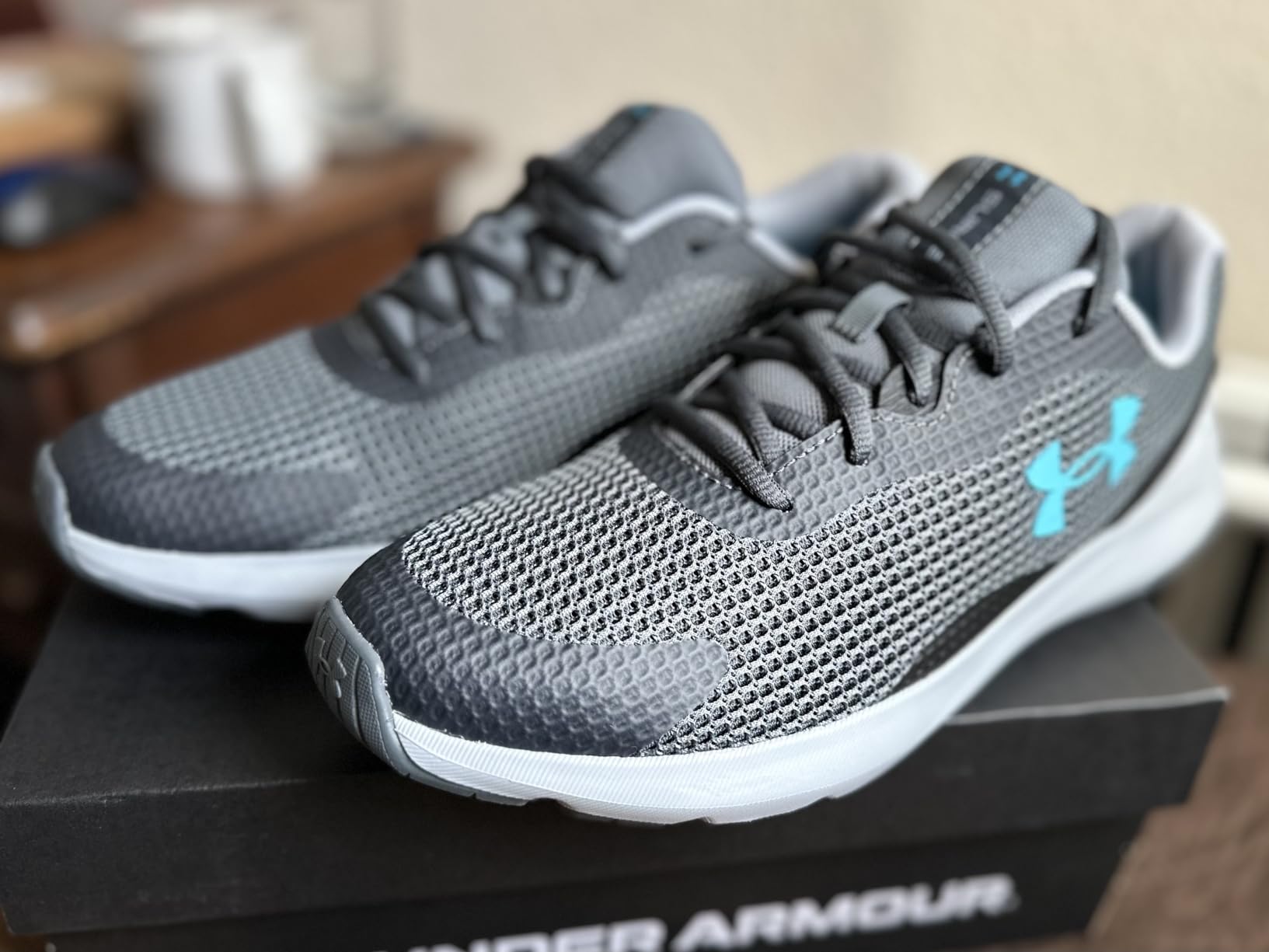 Under Armour Men's Surge 3 running shoe black colorway full product view showing mesh upper and EVA midsole