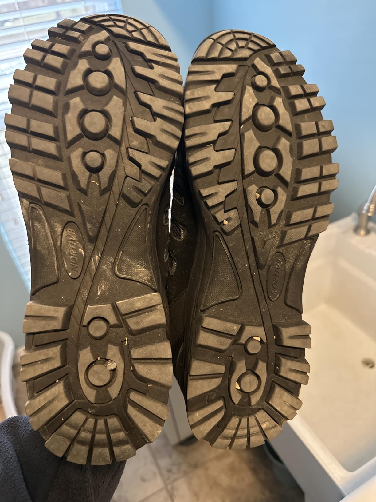 Close-up view of NORTIV 8 hiking shoe showing suede leather upper construction and metal eyelet details