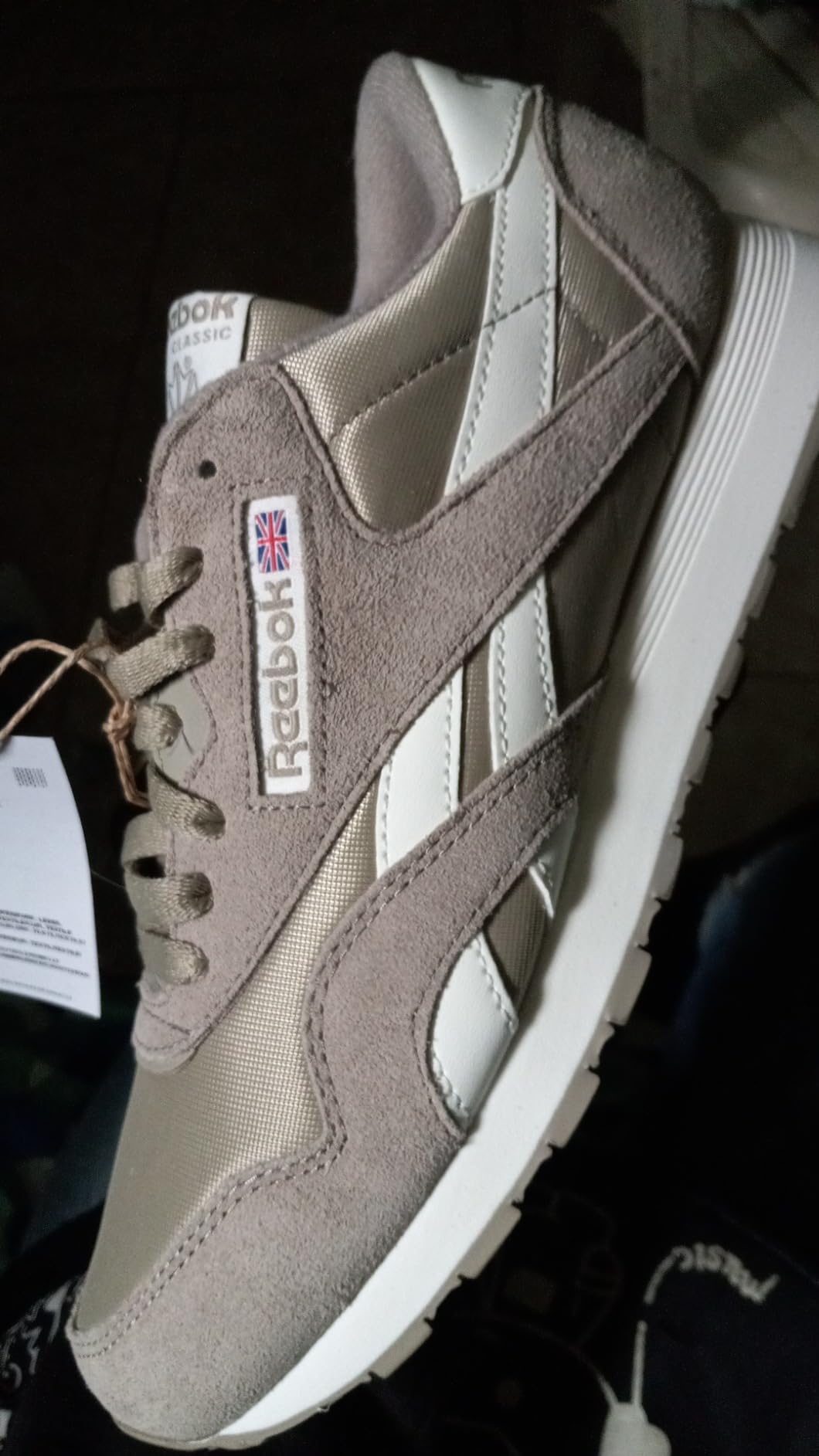 Reebok Classic sneaker heel area and branding detail showing construction seam quality and material interface