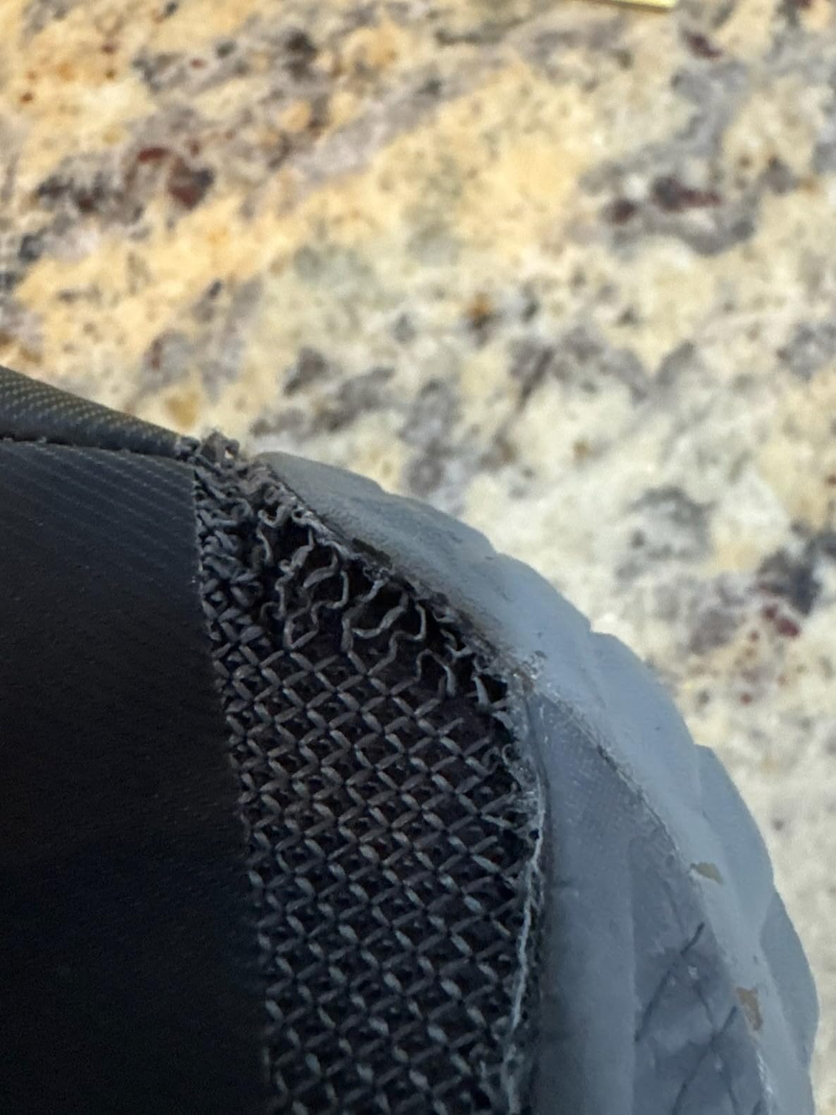 Merrell Trail Glove 6 detailed upper construction showing 65% recycled mesh fabric and leather overlays