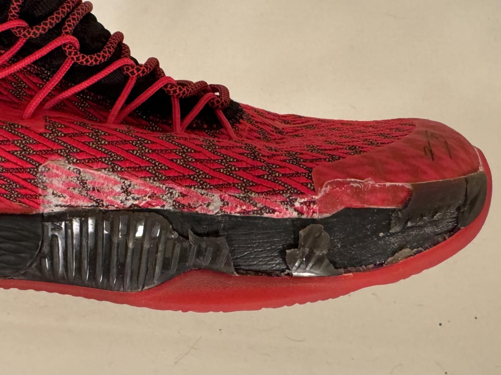 PEAK basketball shoe material separation close-up showing quality control failure at upper junction