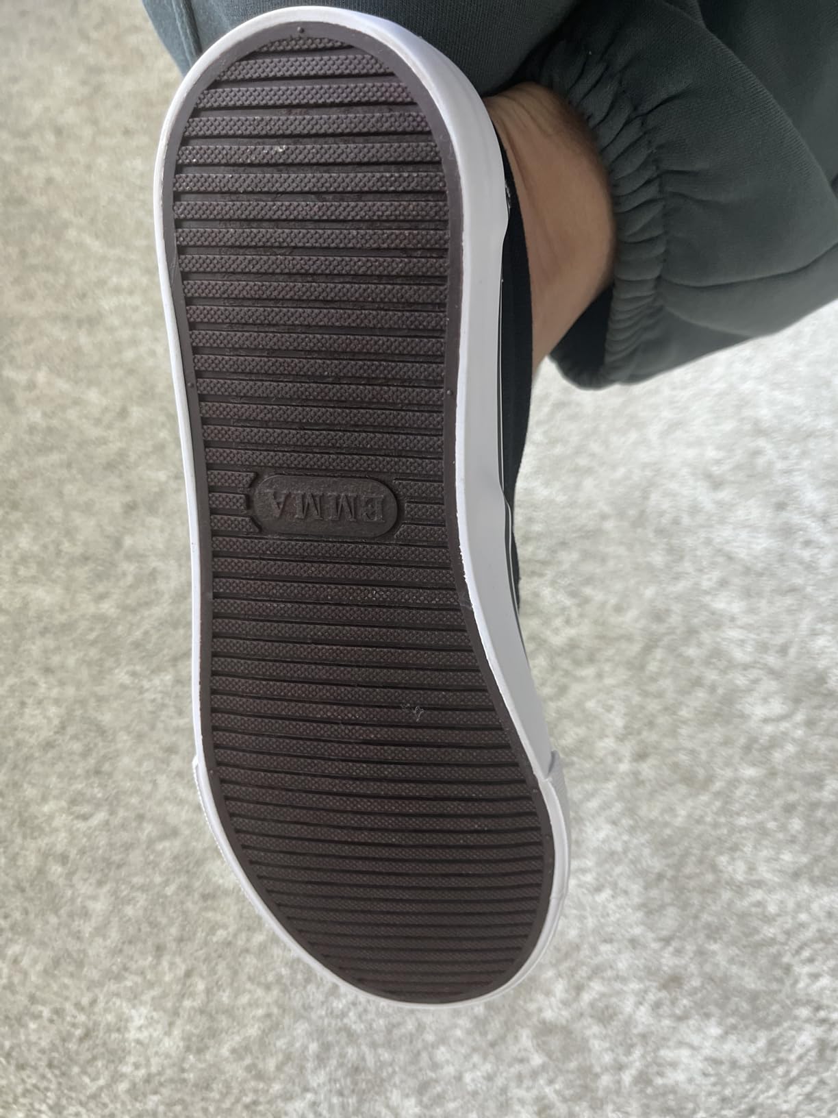 Side profile view of Emma slip-on sneaker showing flat sole profile and minimal heel elevation
