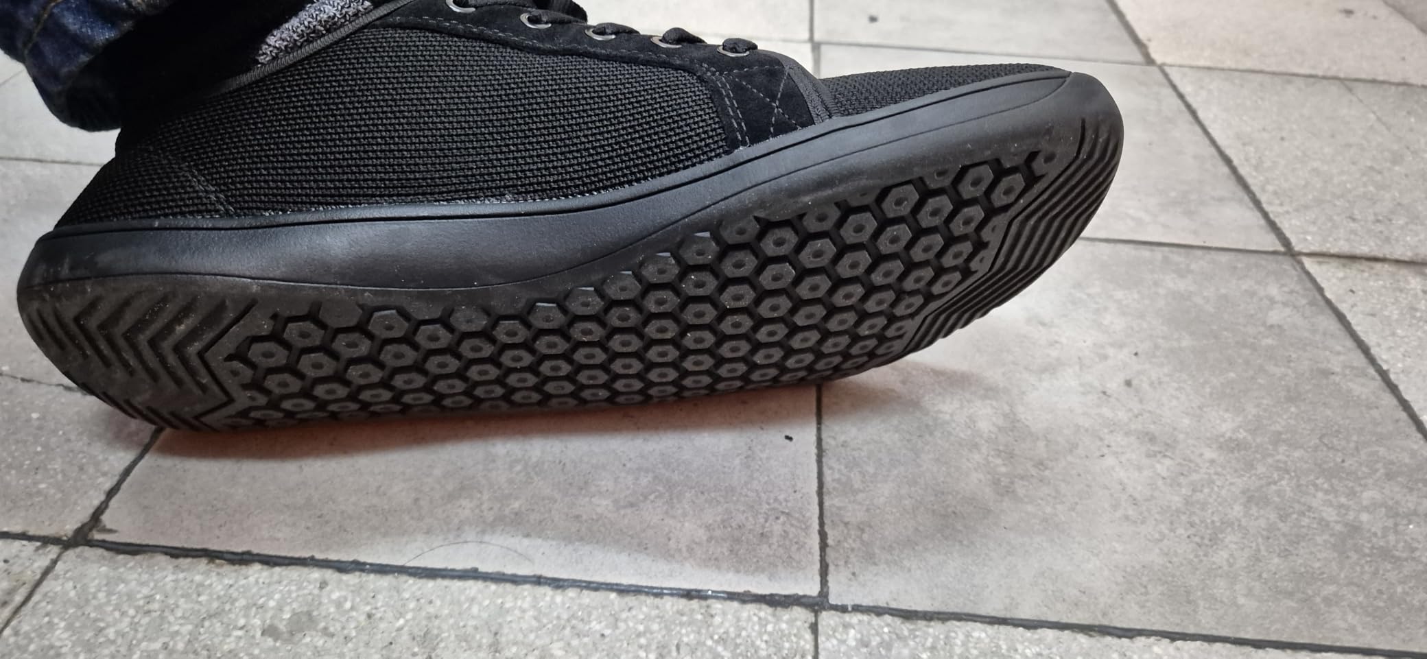 Side profile of WHITIN barefoot sneakers showing the flat zero drop sole and ground contact design
