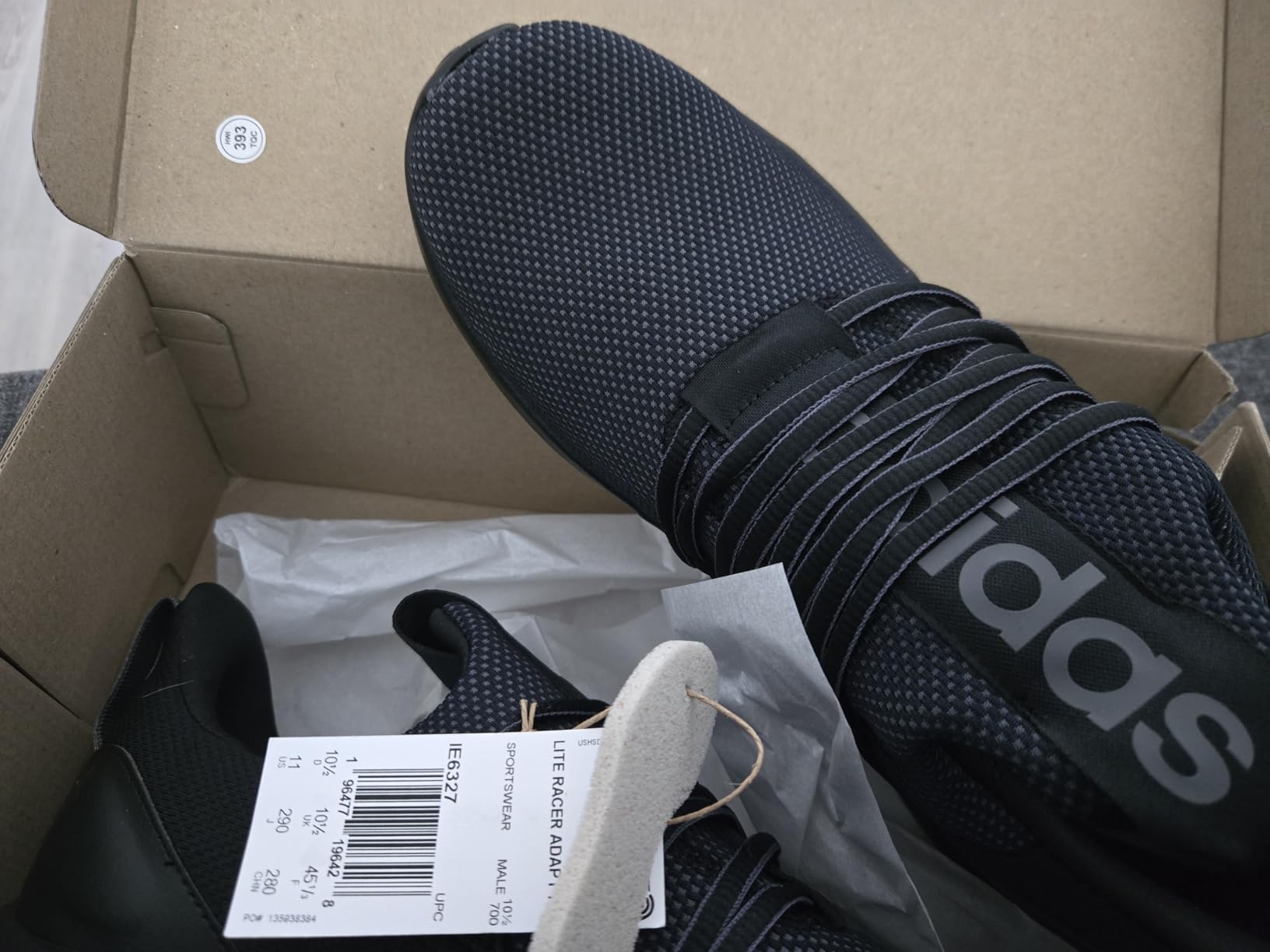 Adidas Lite Racer Adapt 7.0 showing manufacturing quality details on new pair out of box