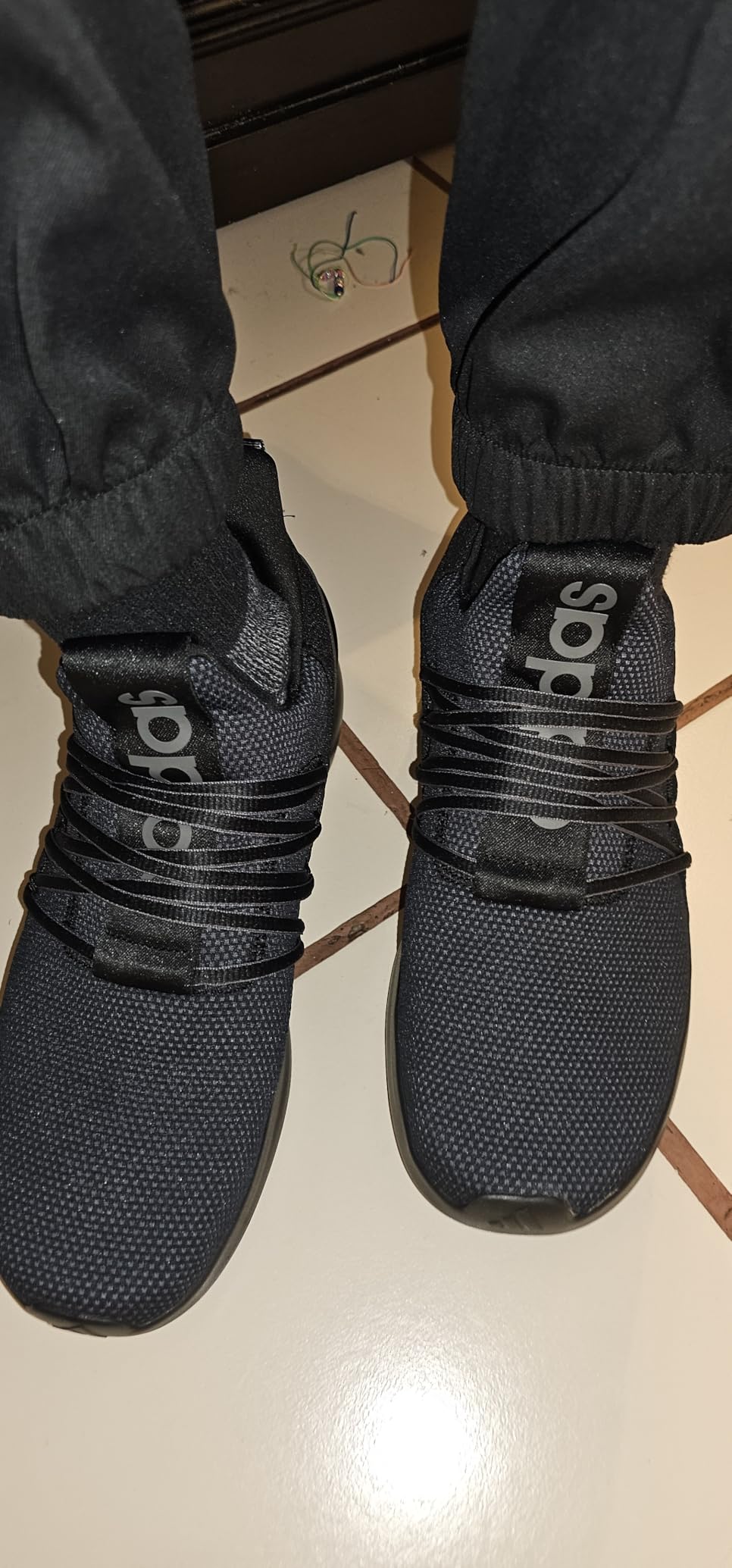 Bottom view of Adidas Lite Racer Adapt 7.0 rubber outsole showing tread pattern and grip surface