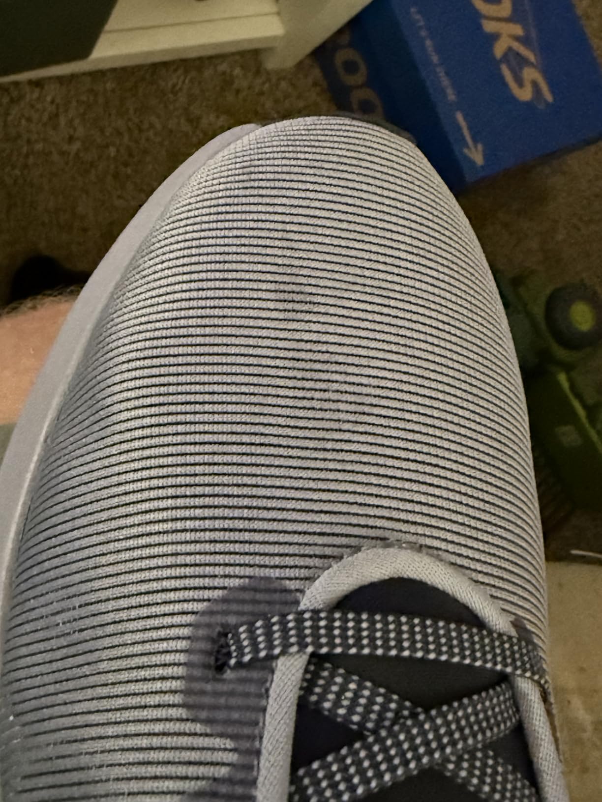 Nike Downshifter 12 side angle showing midsole cushioning height and rubber outsole pattern