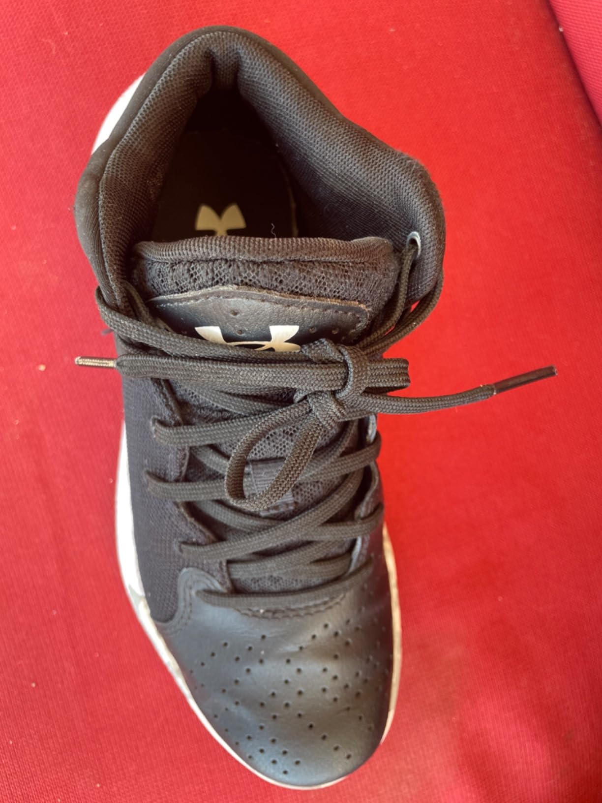 Under Armour Kids Jet 21 basketball shoe action shot showing ankle support performance during youth basketball game