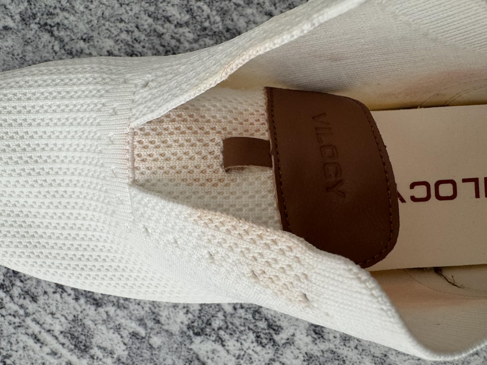 Water damage on VILOCY sneakers showing leather dye bleeding into mesh after rain exposure