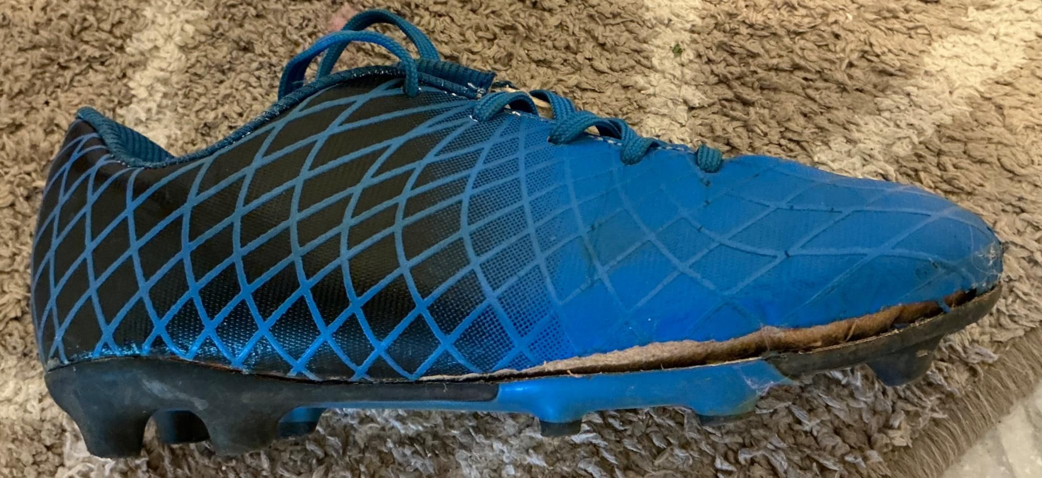 Side profile of JABASIC kids cleats highlighting the bright heel counter and overall design