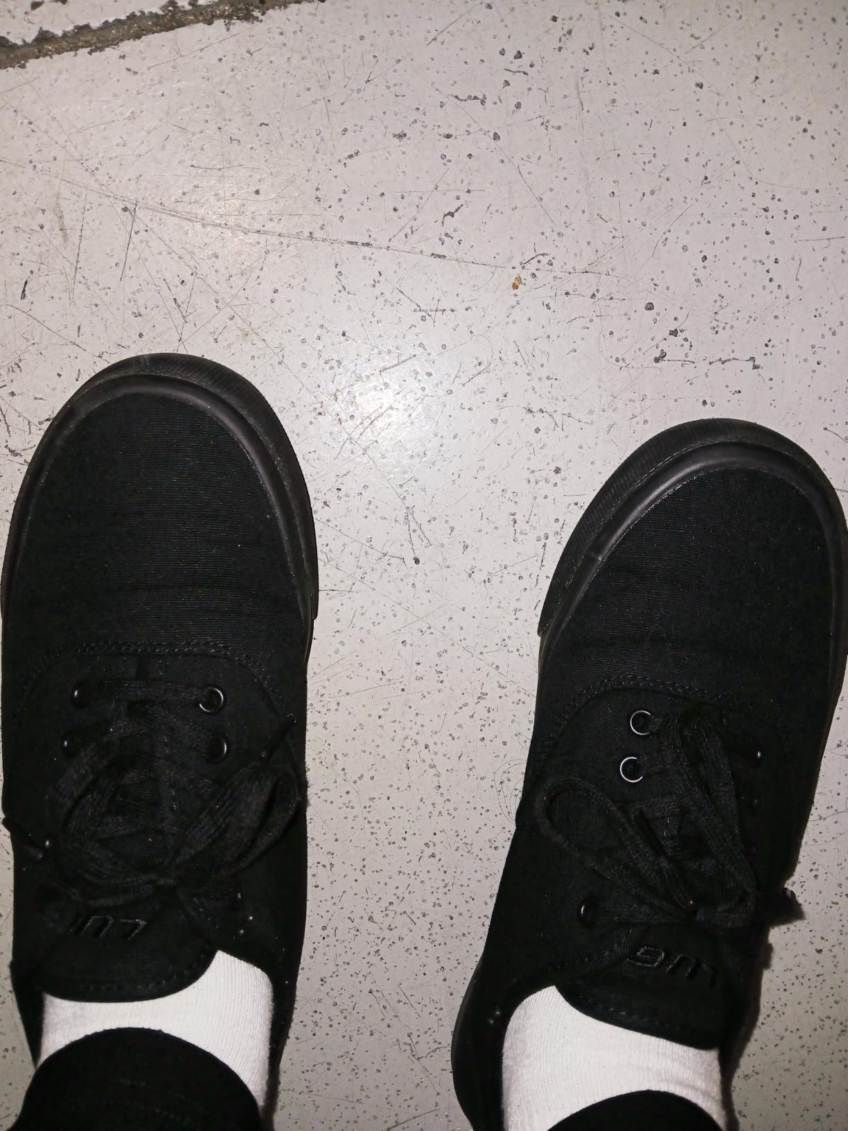 Lugz Women's Lear Wide Sneaker in all-black canvas with white vulcanized sole and lace-up closure