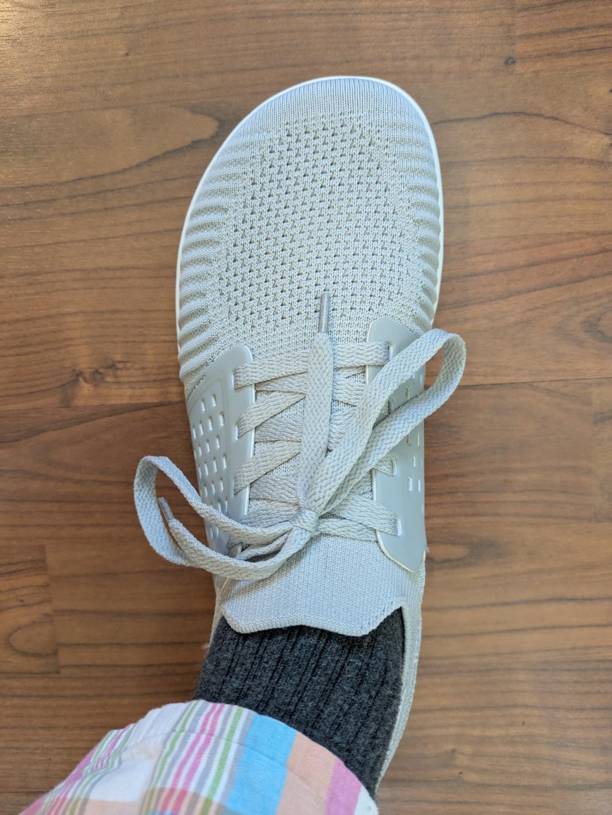 Close-up of WHITIN barefoot shoe showing open engineered knit mesh upper construction and lacing system detail