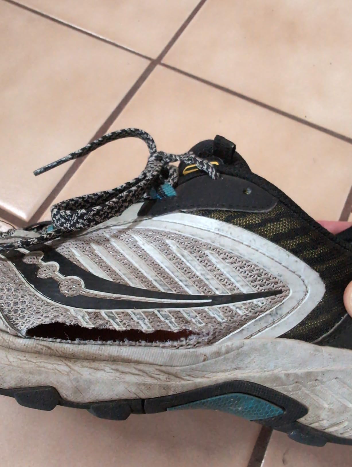 Side profile of Saucony TR15 after extensive trail testing showing visible wear patterns and dirt accumulation
