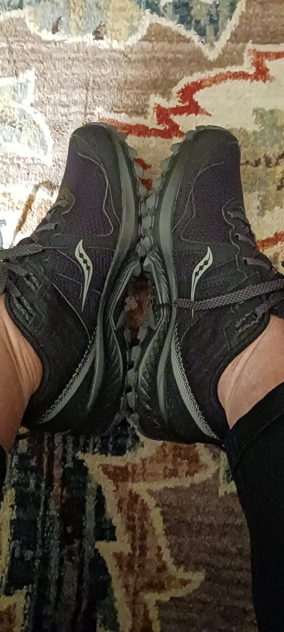 Healthcare professional showing 12+ hour shift comfort validation for Saucony TR14