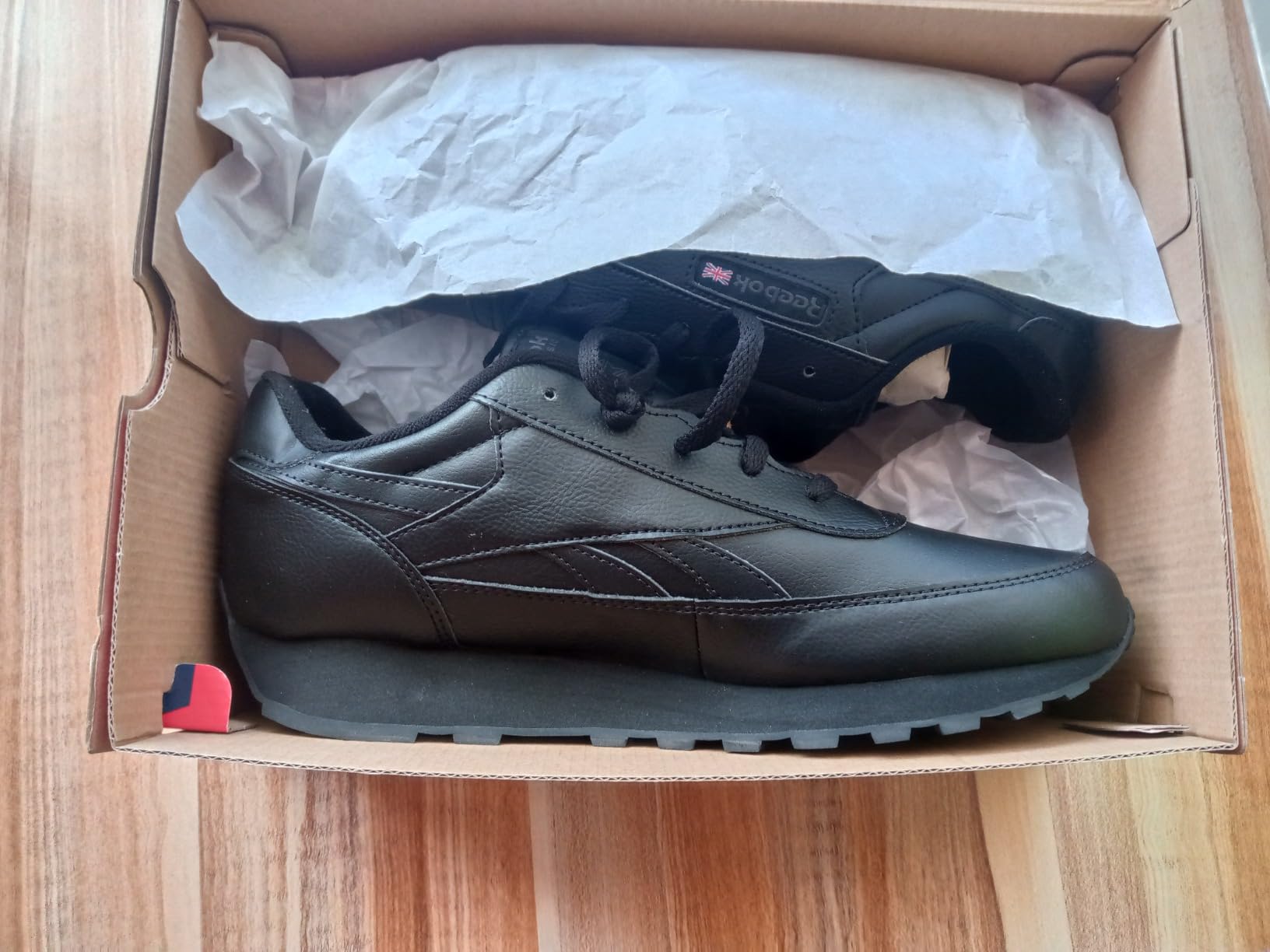 Reebok Men's Classic Renaissance sneaker in black and grey colorway showing leather upper construction