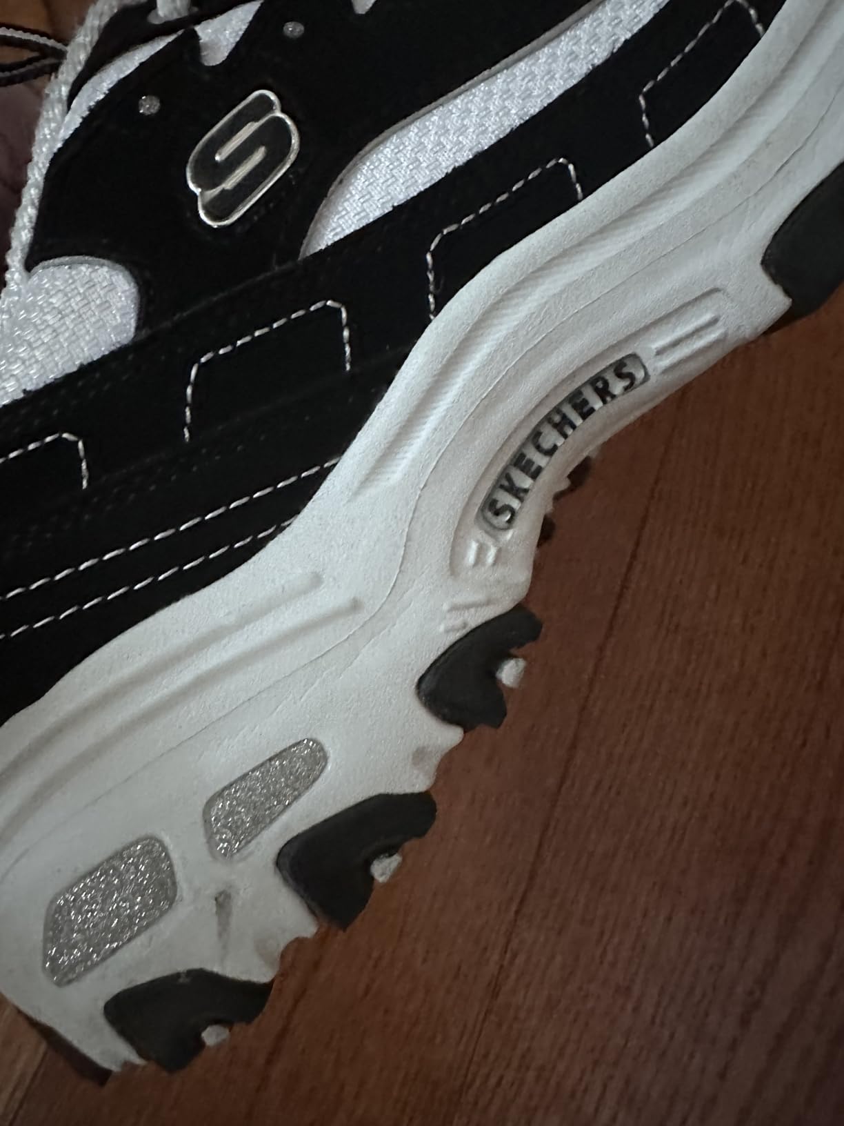 Skechers Women's D'Lites Me Time sneakers in black and white showing classic chunky sole design and memory foam comfort