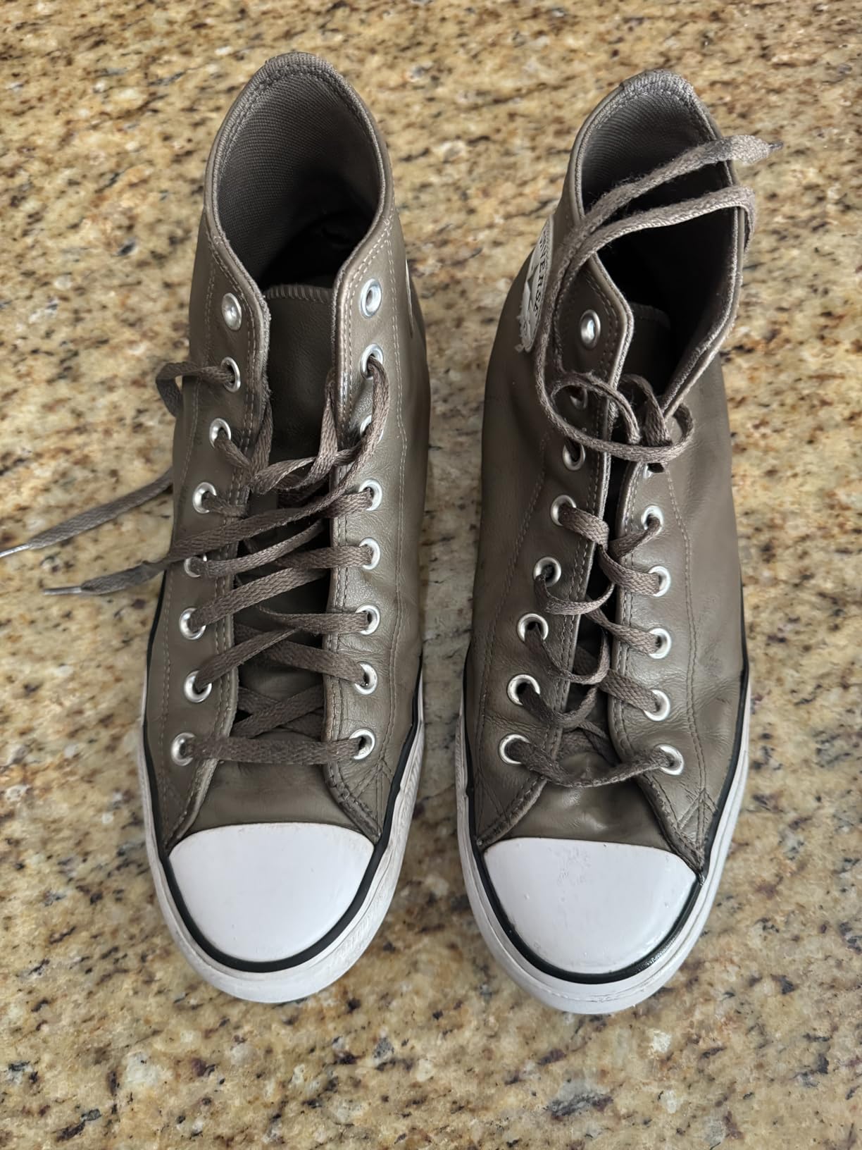 Multiple pairs of family sneakers after cleaning session showing SneakERASERS results on various shoe types