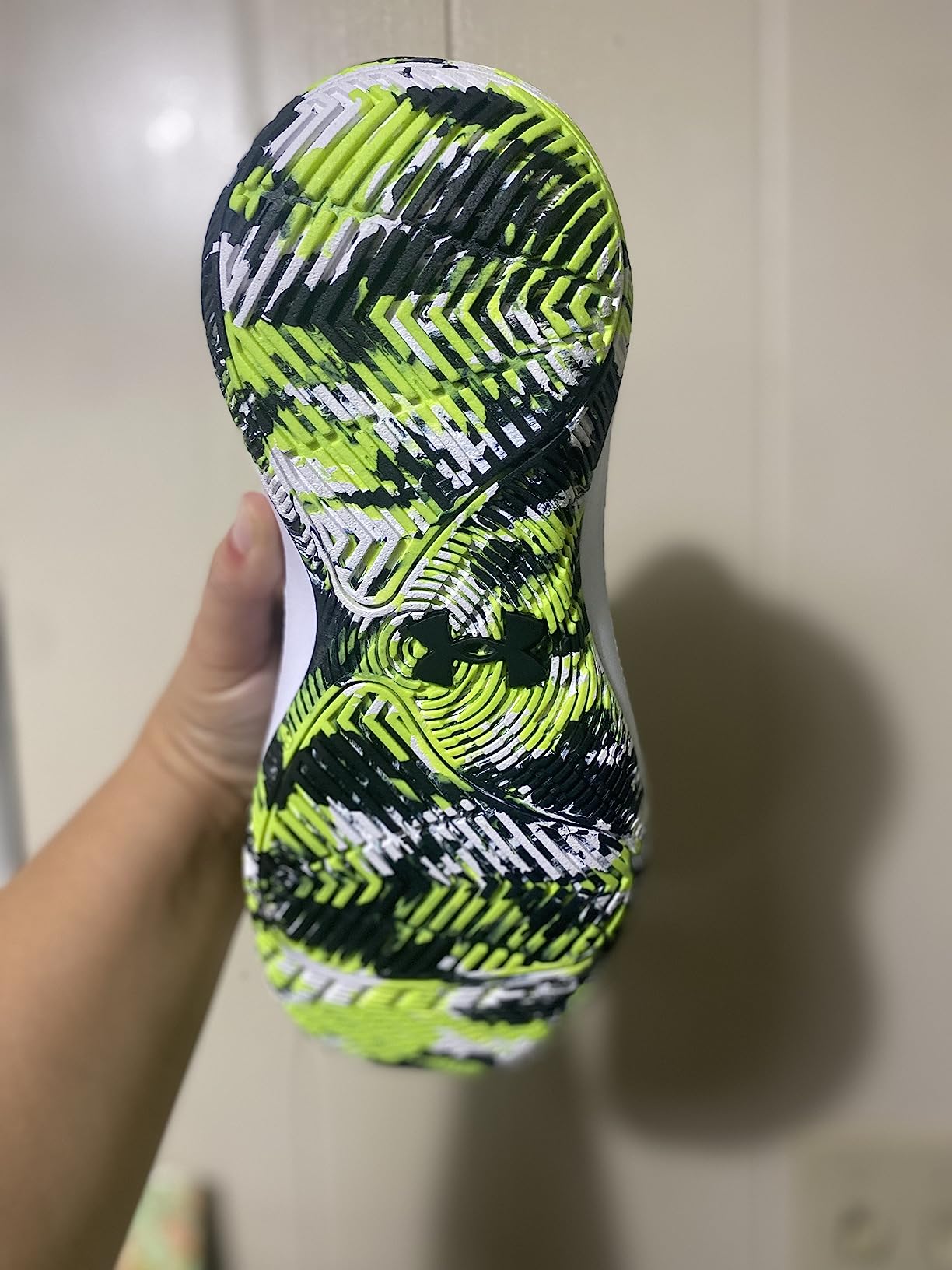 Under Armour Jet 21 kids basketball shoe side profile showing leather upper construction and ankle collar height