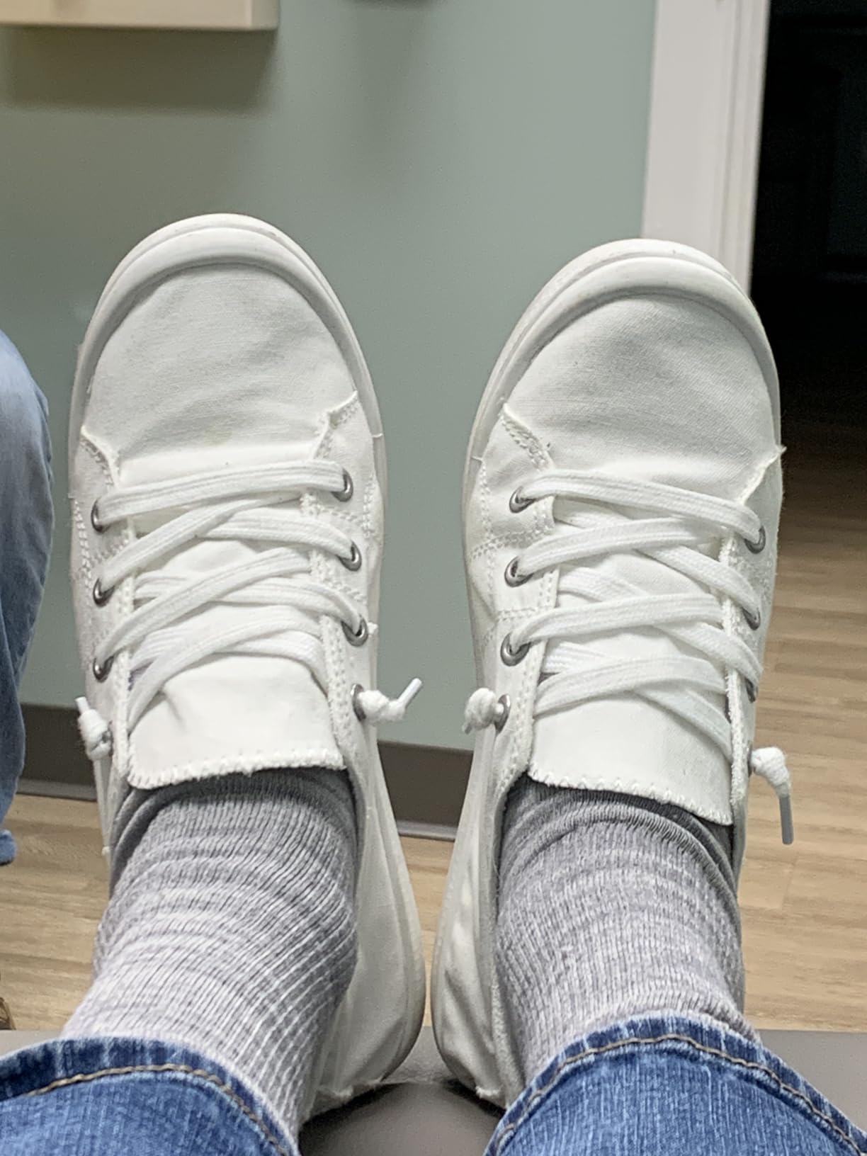 White Beneker canvas sneakers shown on feet demonstrating comfortable casual fit and low-profile silhouette