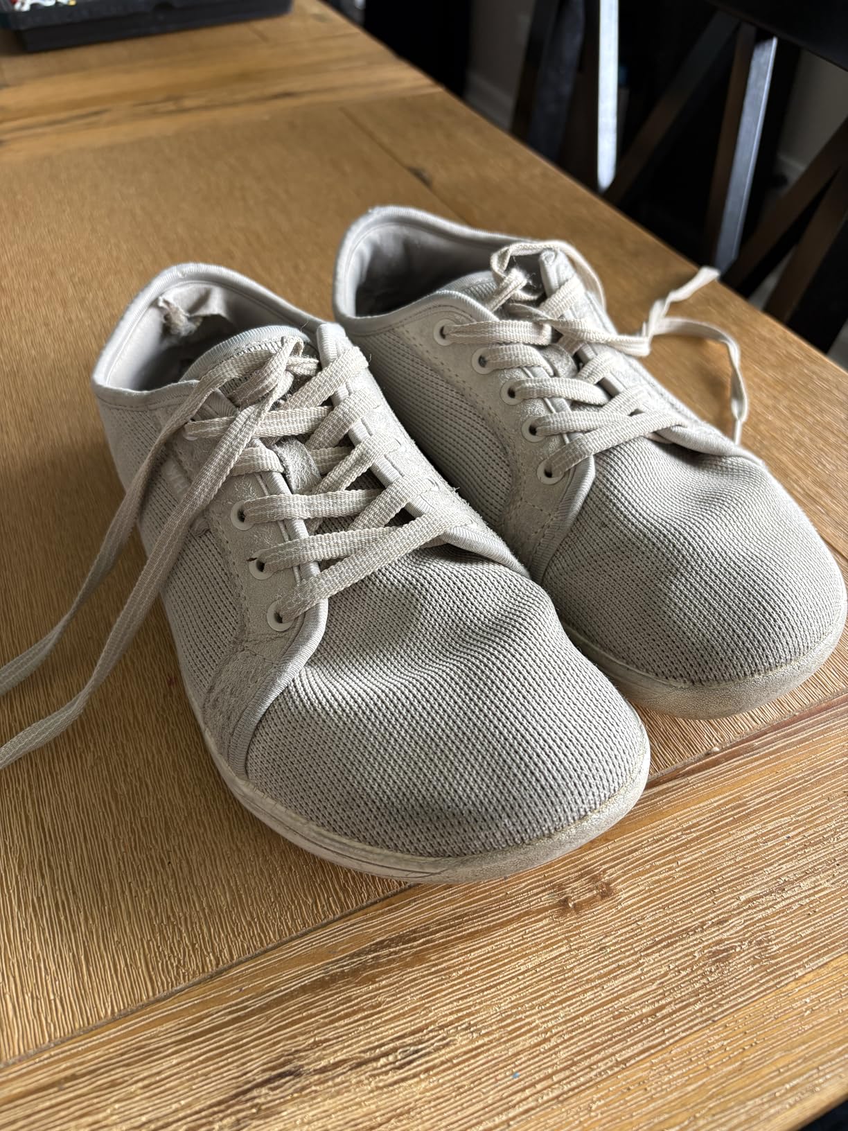 Worn WHITIN barefoot shoes after extended use showing sole wear patterns and durability test