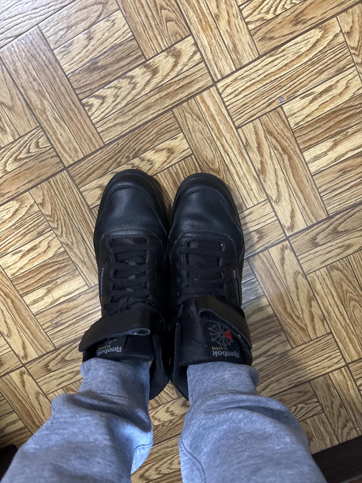 Close-up of Reebok EX-O-FIT HI leather upper construction and velcro ankle strap showing snug fit design