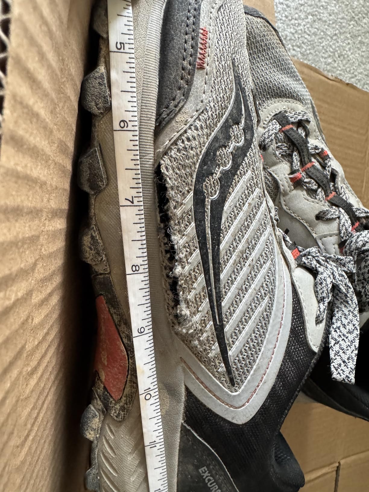 Detailed view of mesh upper deterioration on Saucony TR15 showing stress points and separation common in budget trail shoes