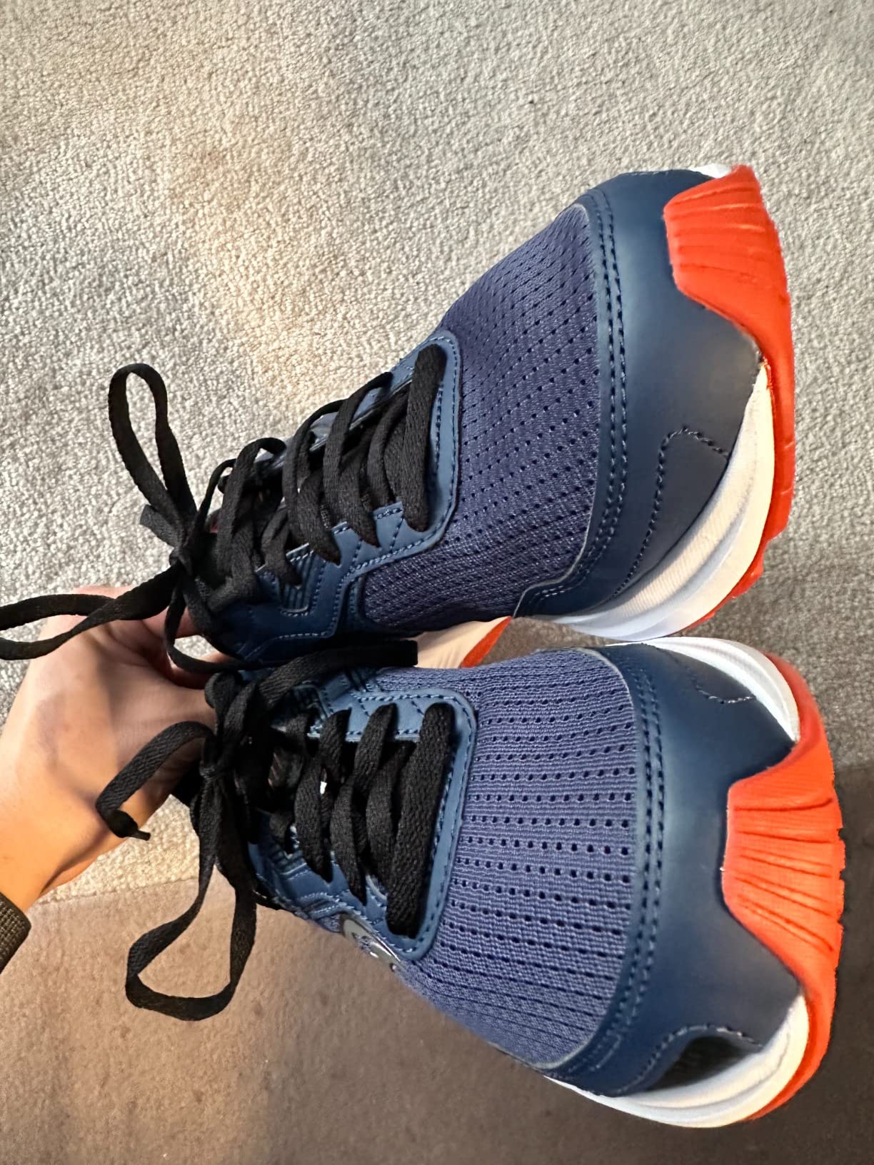 Bottom view of Saucony Cohesion 16 rubber outsole showing tread pattern and lug configuration for multi-surface traction