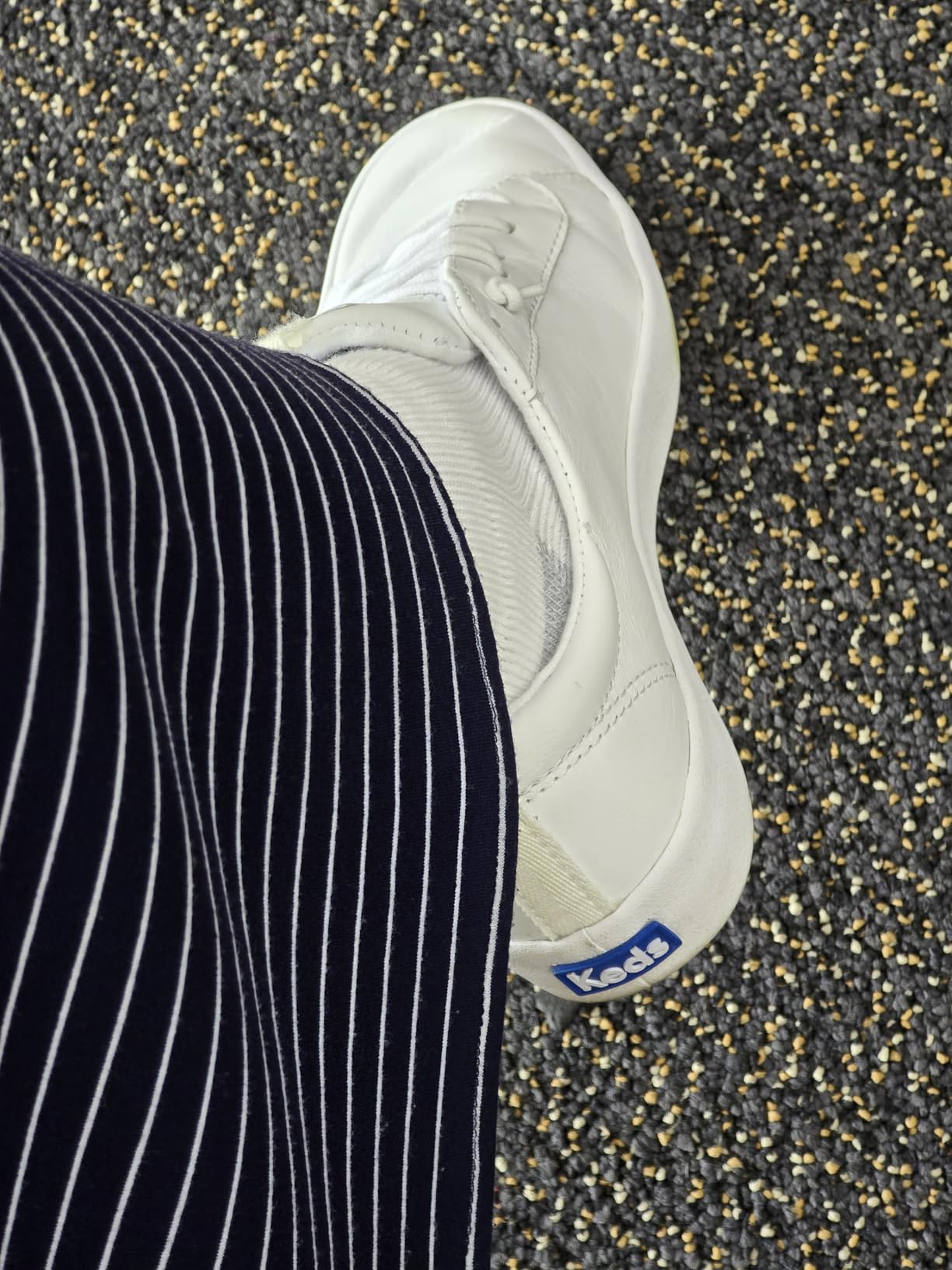 Close-up of Keds Kickback embroidered eyelets and stretch gore construction showing slip-on mechanism