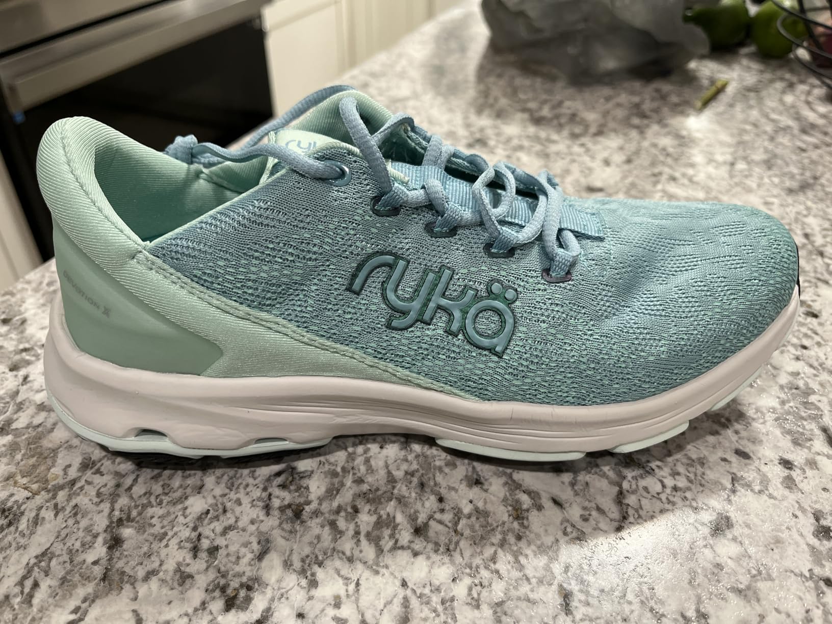 Ryka Devotion X in blue colorway on a walking path, showing the shoe in outdoor fitness context
