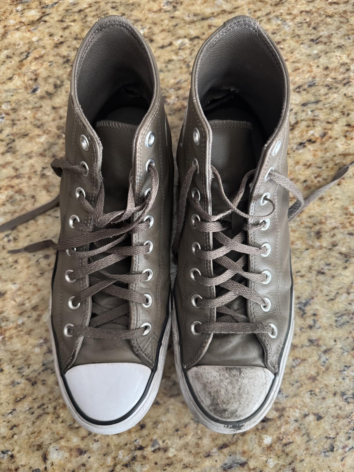 Collection of clean white sneakers and family shoes after four weeks of SneakERASERS testing showing consistent results