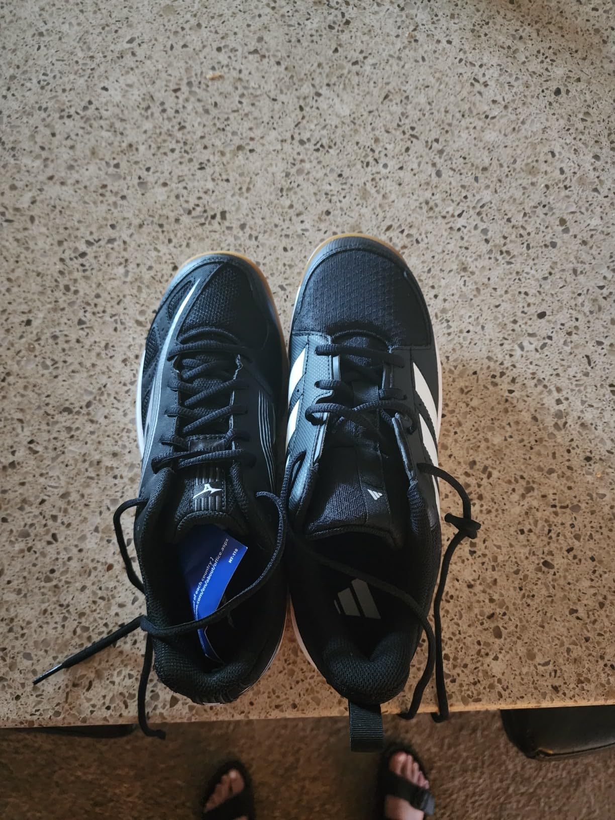 adidas Ligra 7 side view showing mesh upper construction and synthetic overlay placement